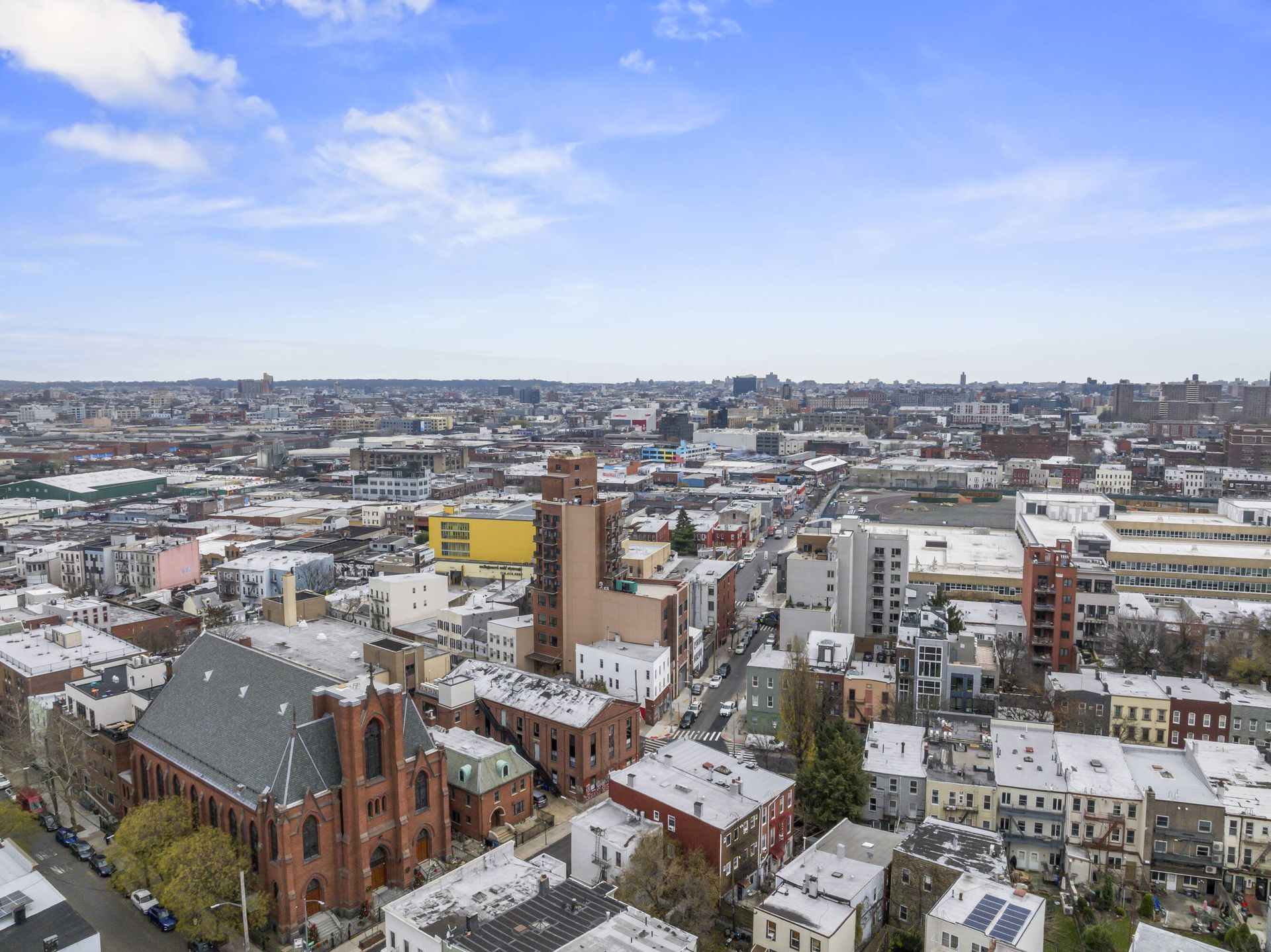 An aerial view of a city with a church in the middle of it.