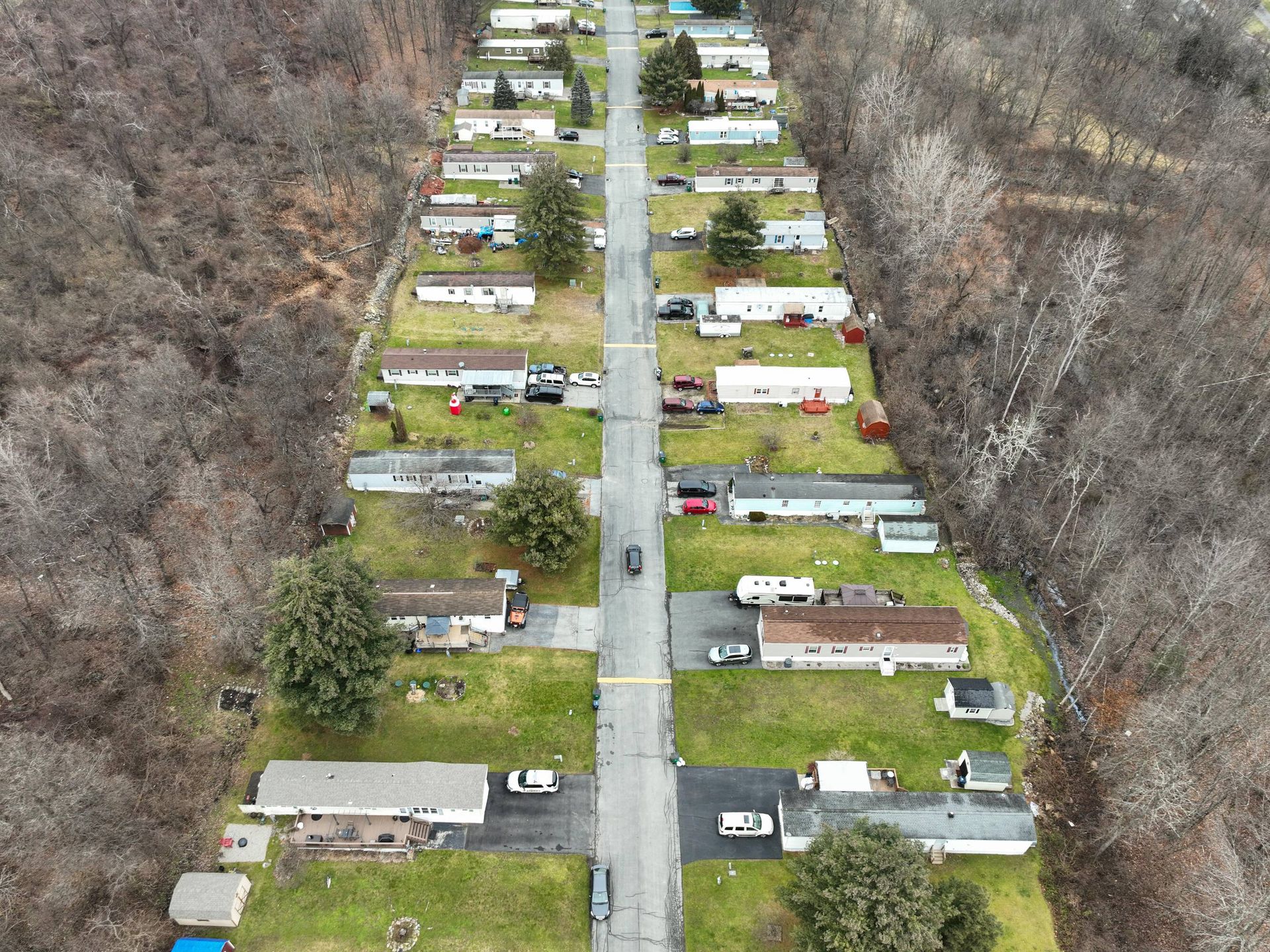 An aerial view of a mobile home park with lots of houses and trees.