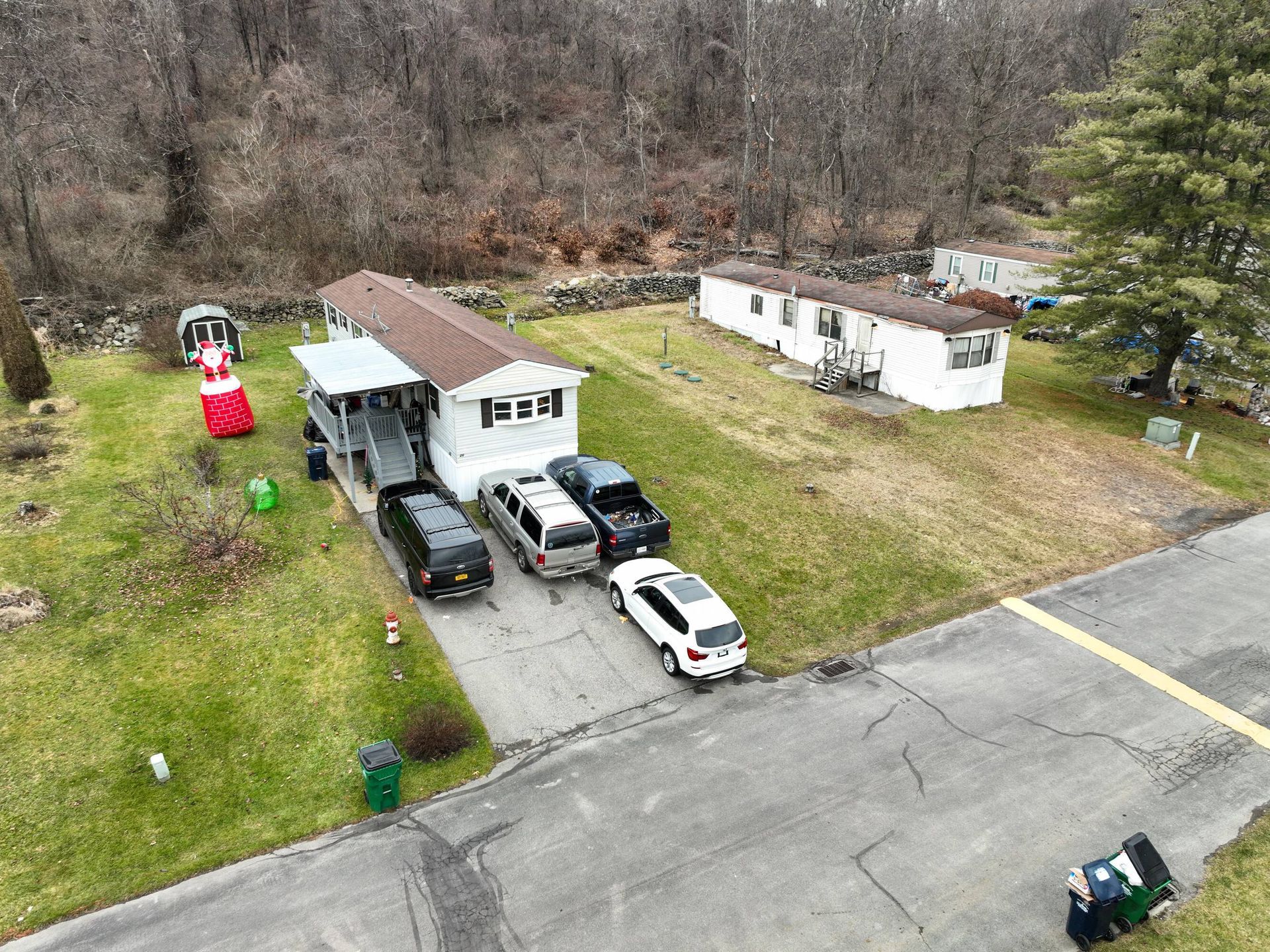 An aerial view of a house with a lot of cars parked in front of it.