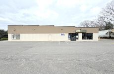 A large building with a lot of parking in front of it.