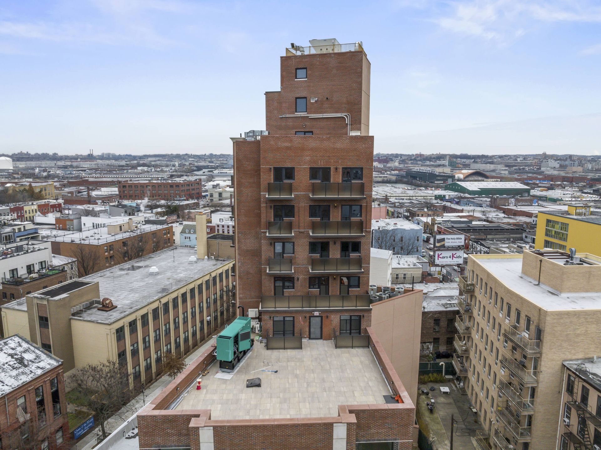 An aerial view of a large brick building in a city