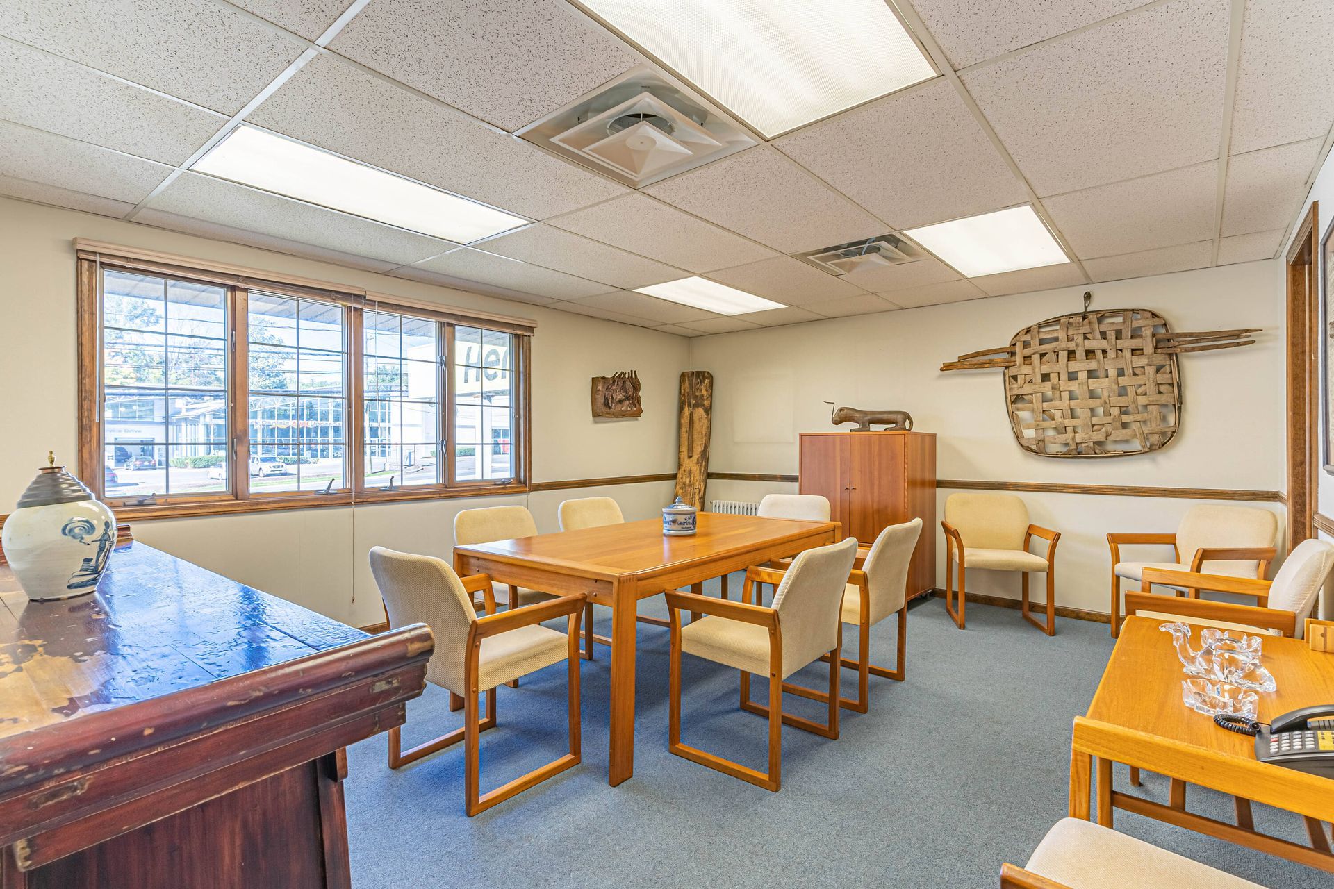 A large room with a table and chairs in it.