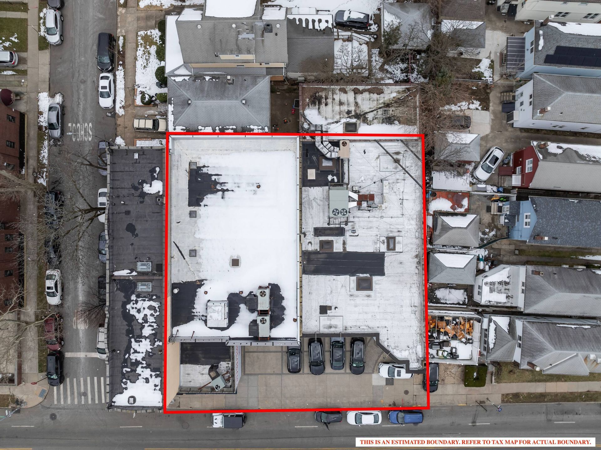 An aerial view of a building with a red outline around it