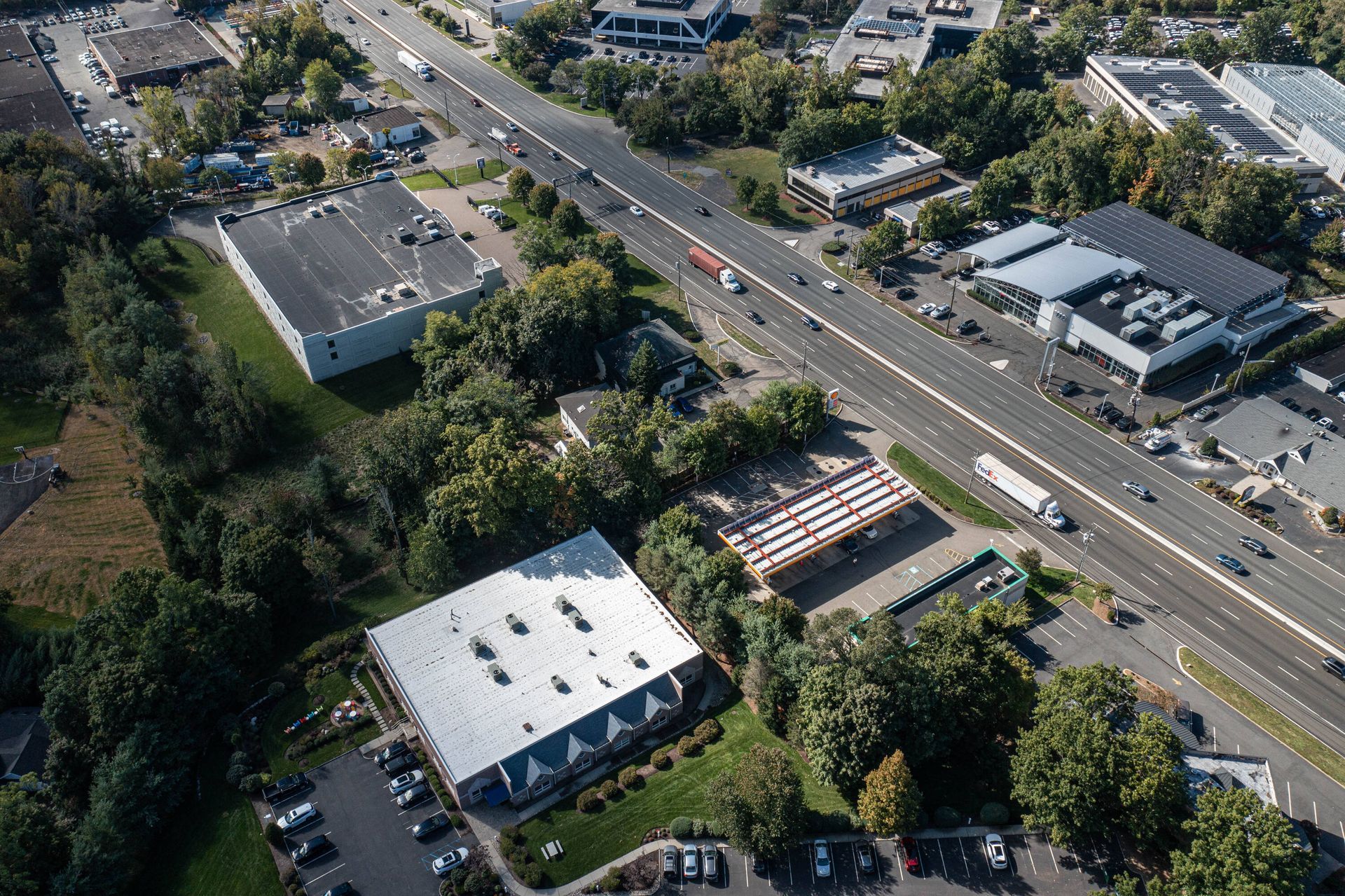 An aerial view of a city with a highway and buildings.