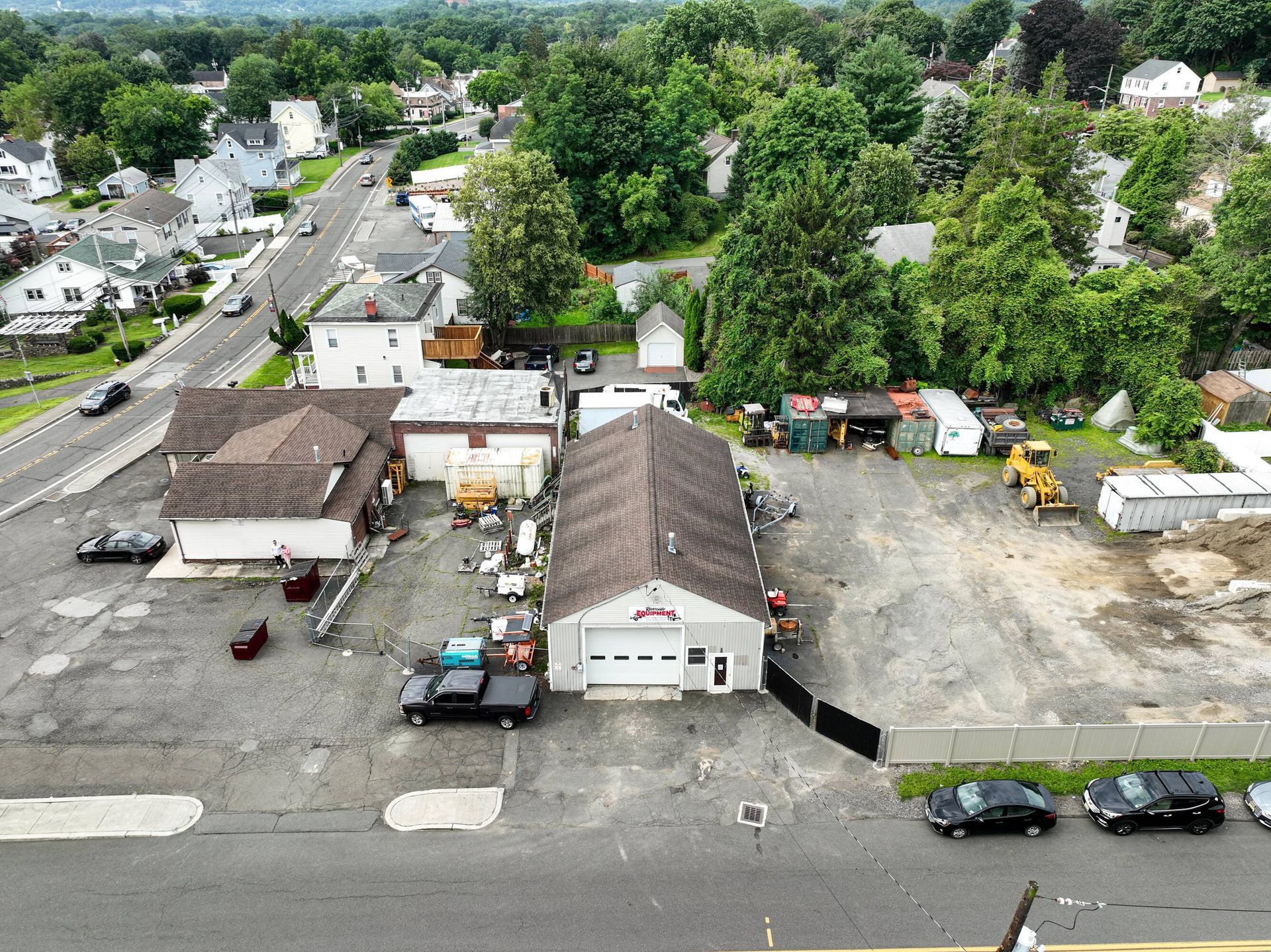 An aerial view of a garage with cars parked in front of it.