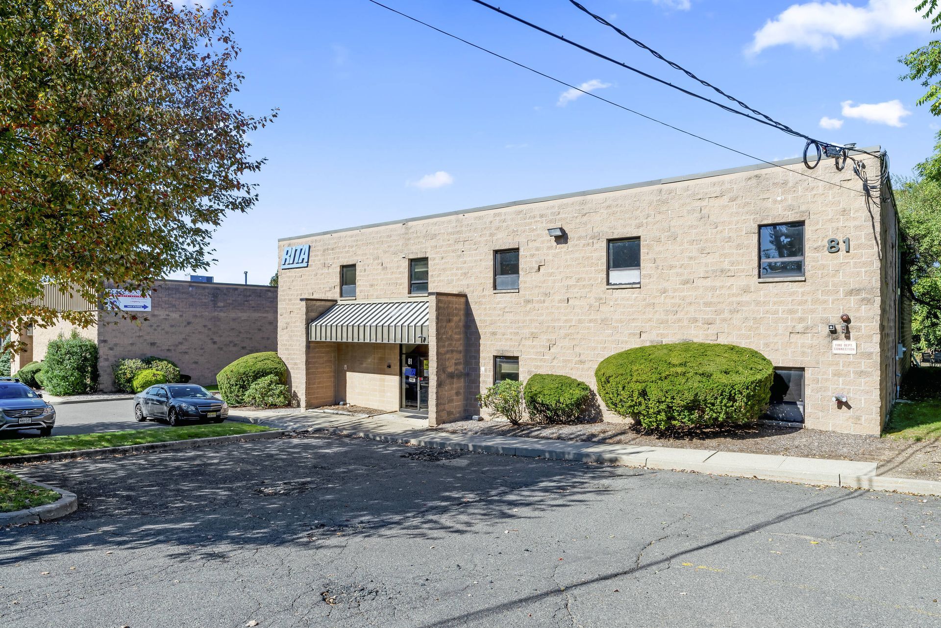 A large brick building with cars parked in front of it