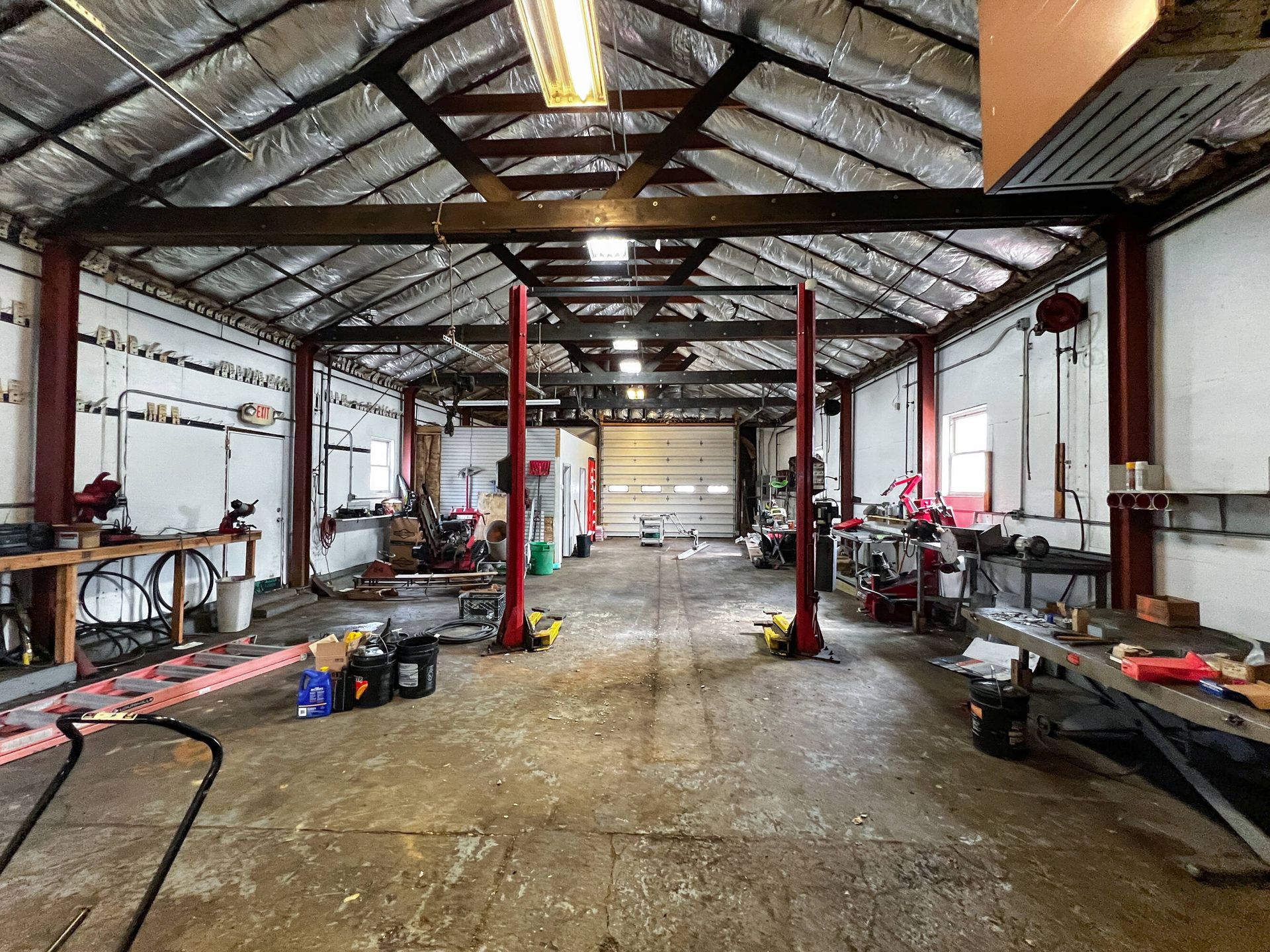 A large empty garage with two lifts in it.