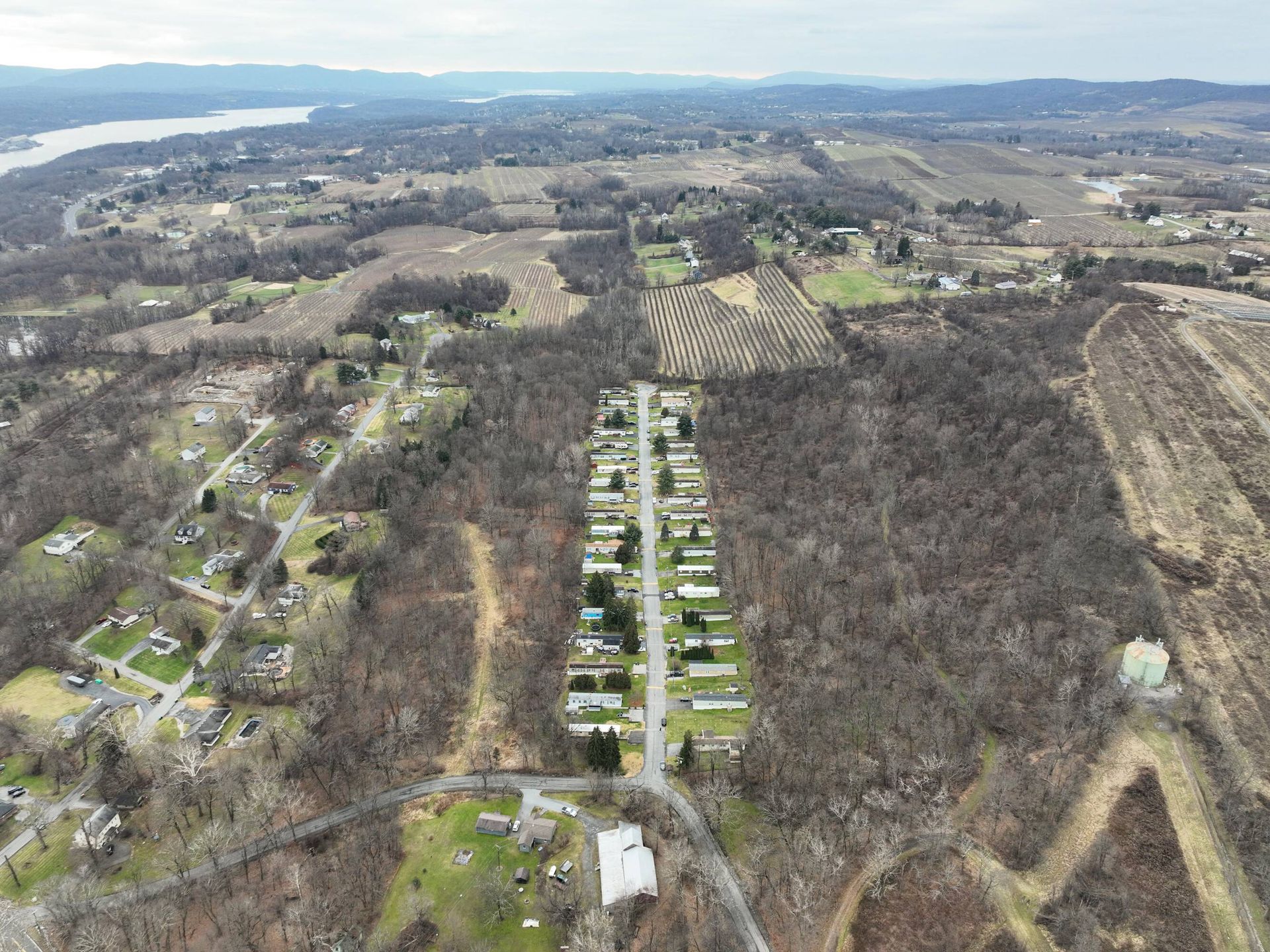 An aerial view of a residential area with a river in the background.