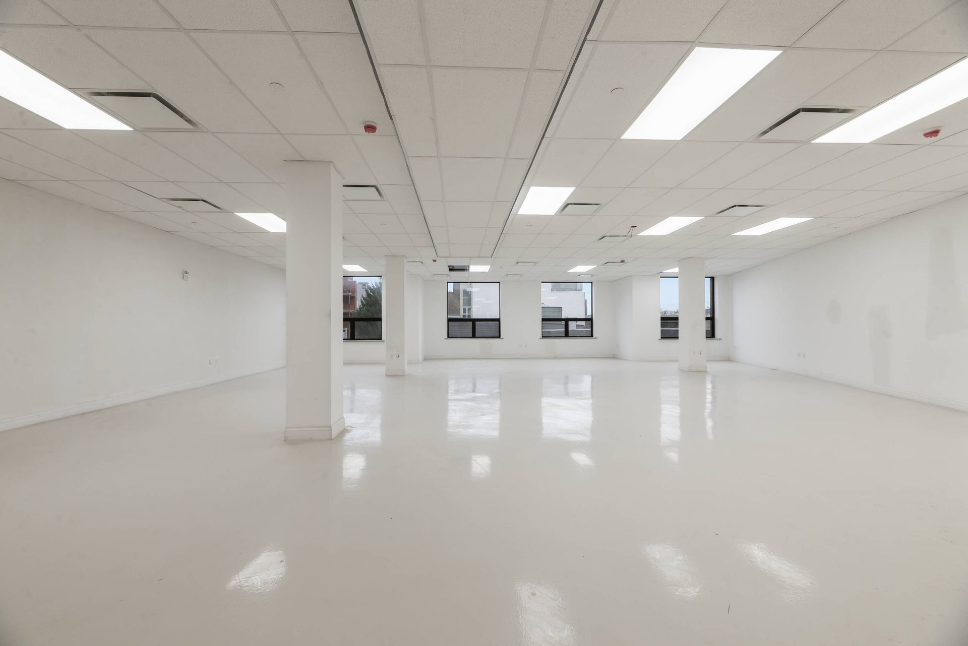 A large empty room with white walls and a white floor.