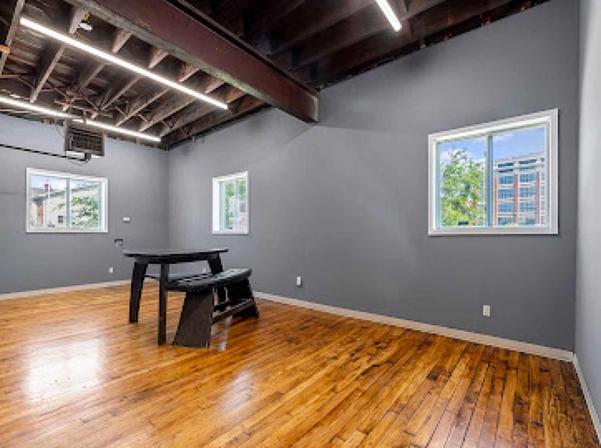 There is a table and bench in the middle of the room.