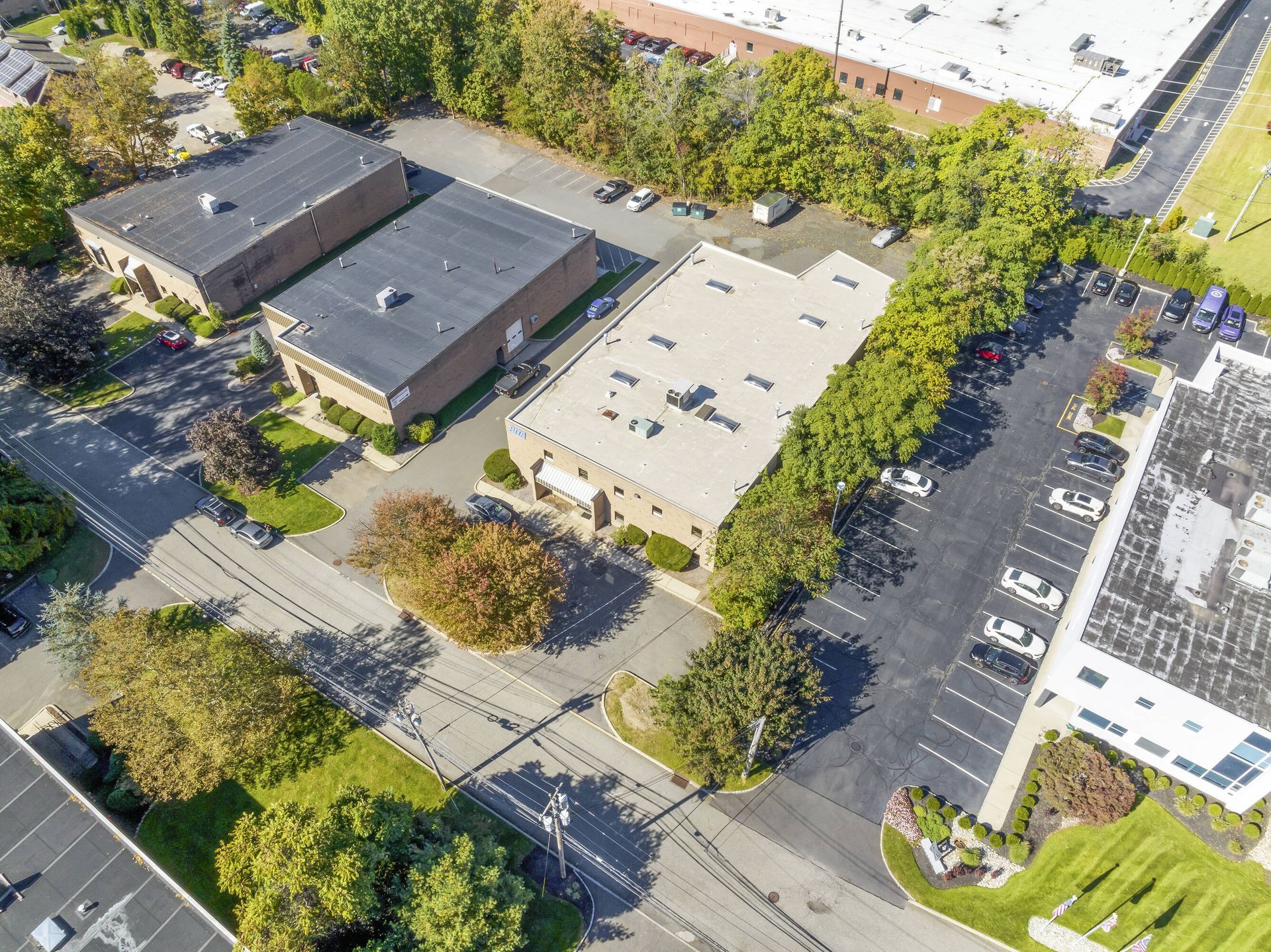 An aerial view of a residential area with buildings and parking lots.