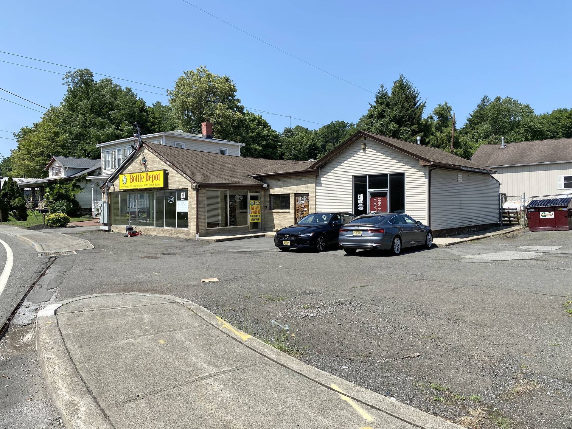 Two cars are parked in front of a building that says taco bell