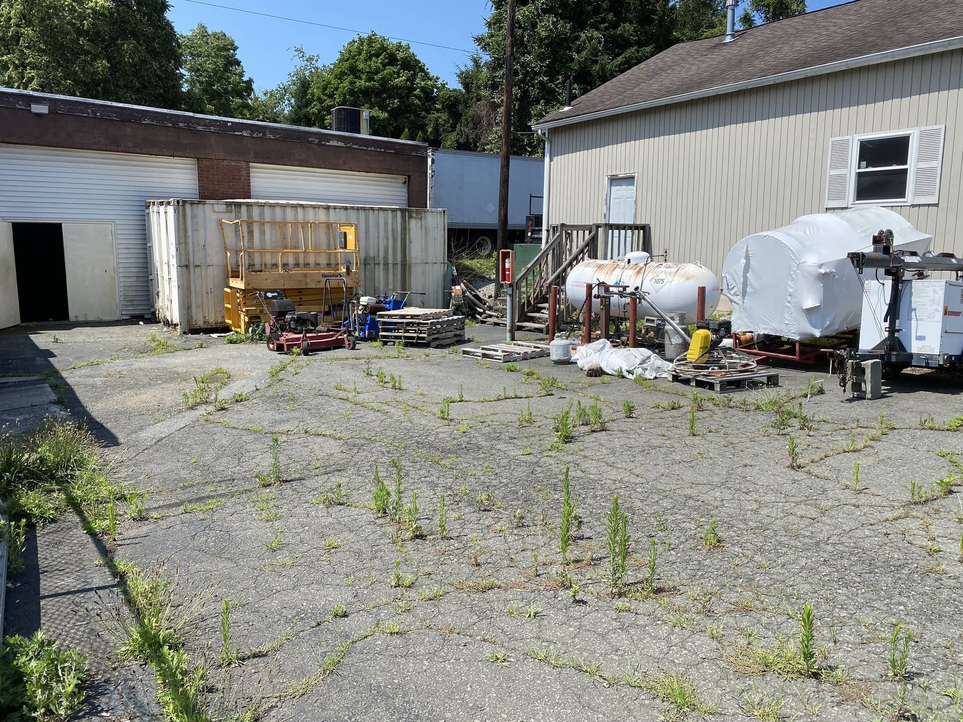 An empty lot with a building in the background