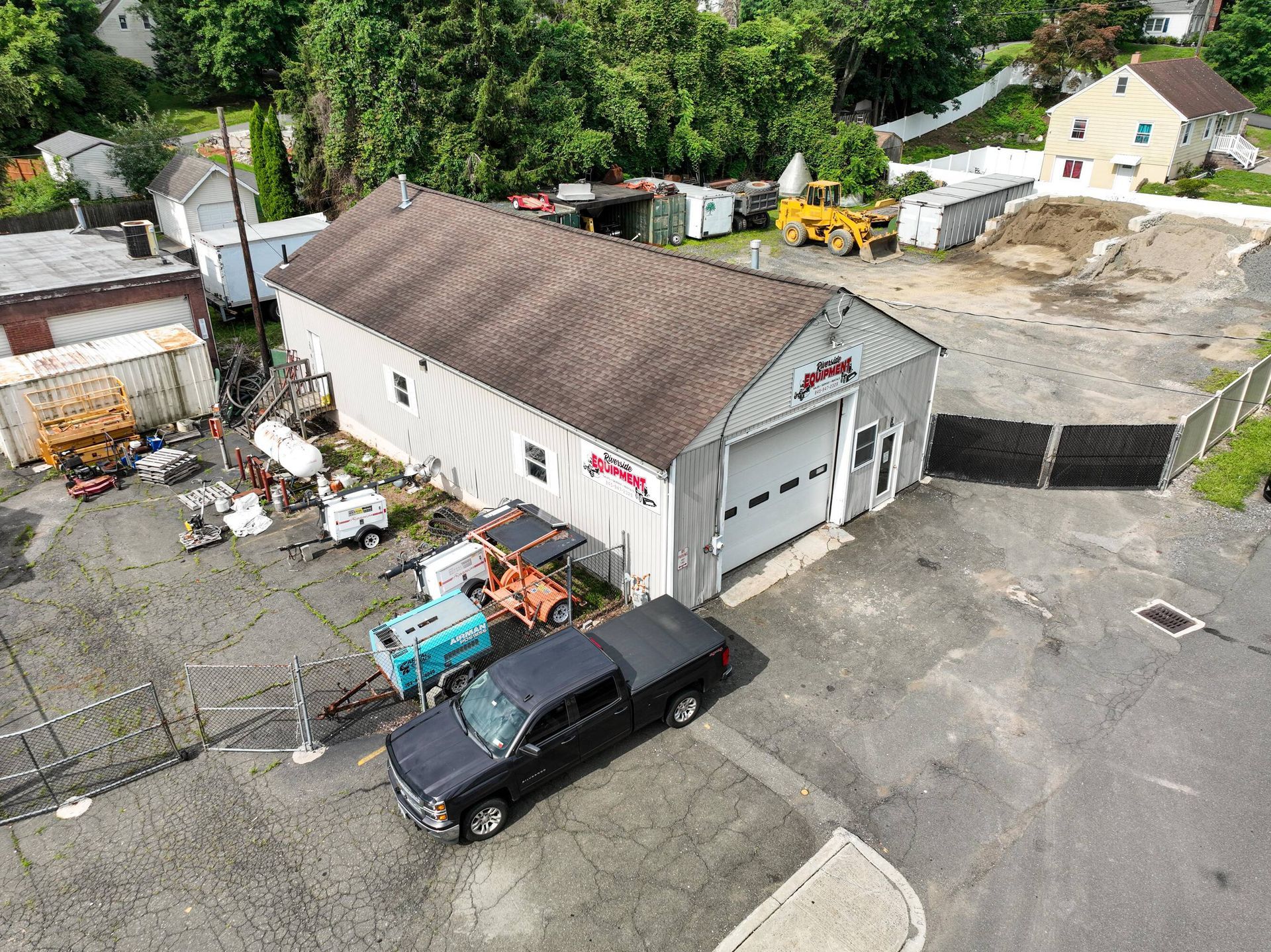 An aerial view of a garage with a truck parked in front of it.
