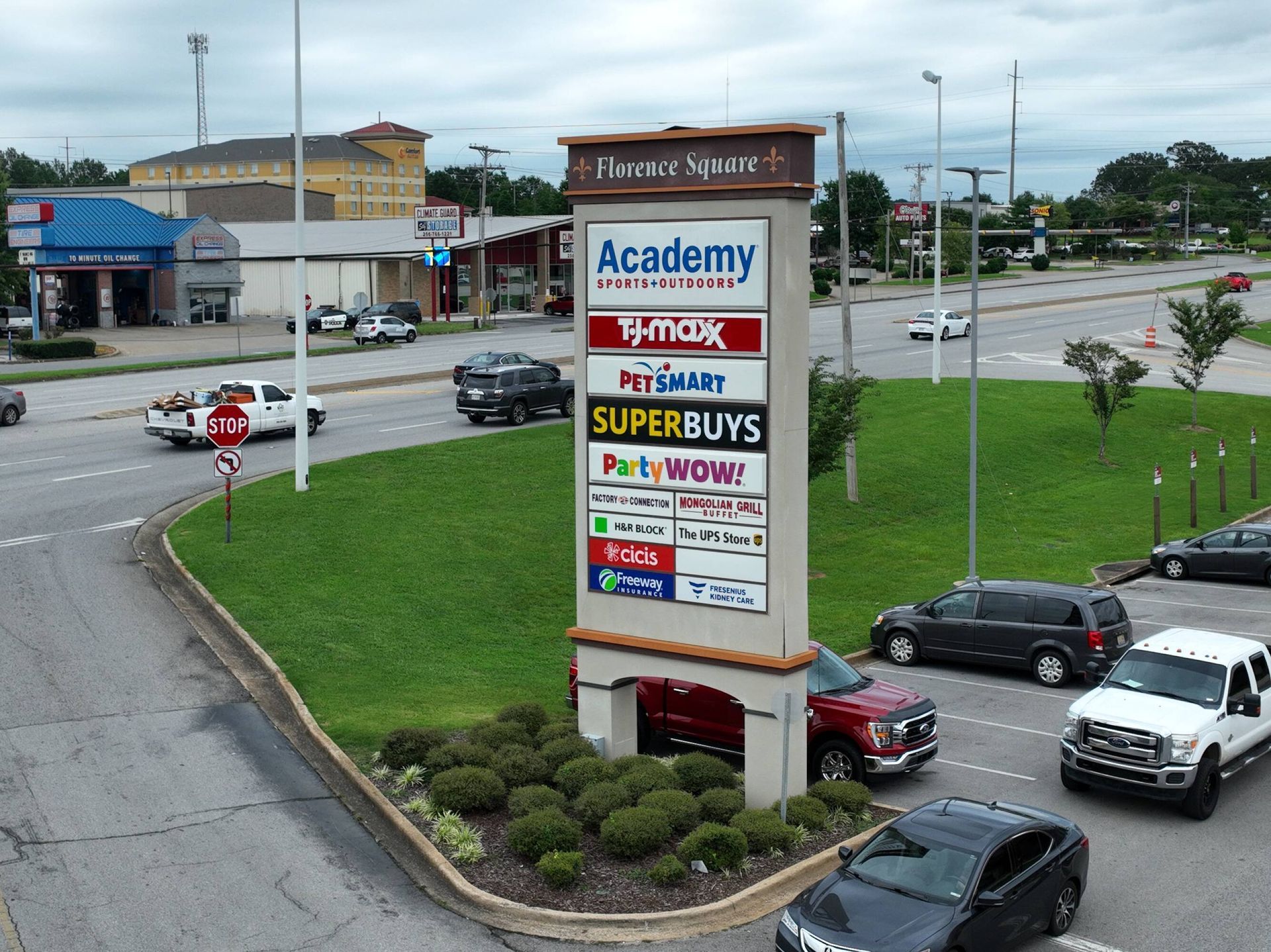 An aerial view of a shopping center with a sign that says academy