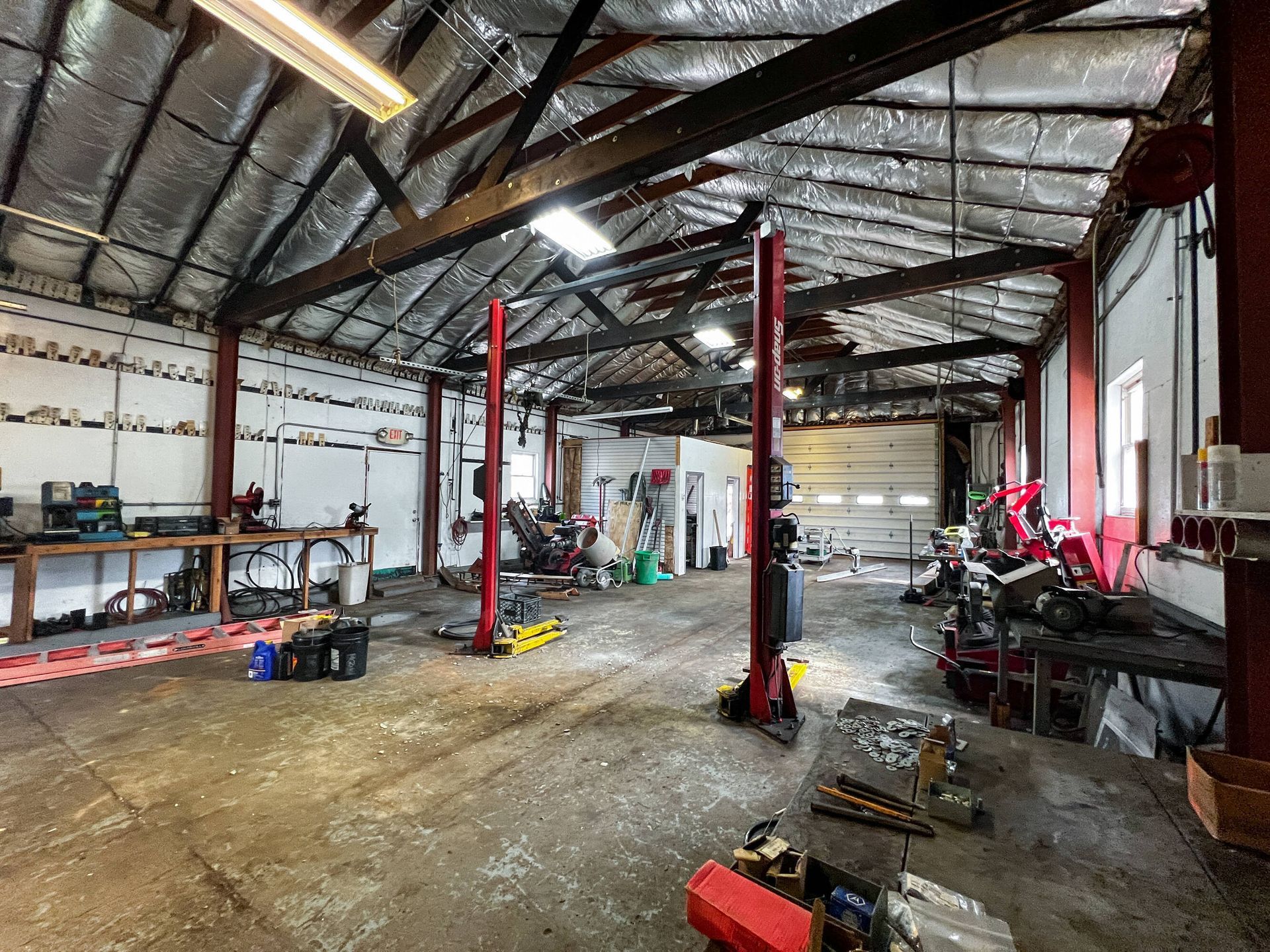 A large empty garage with two lifts in it.