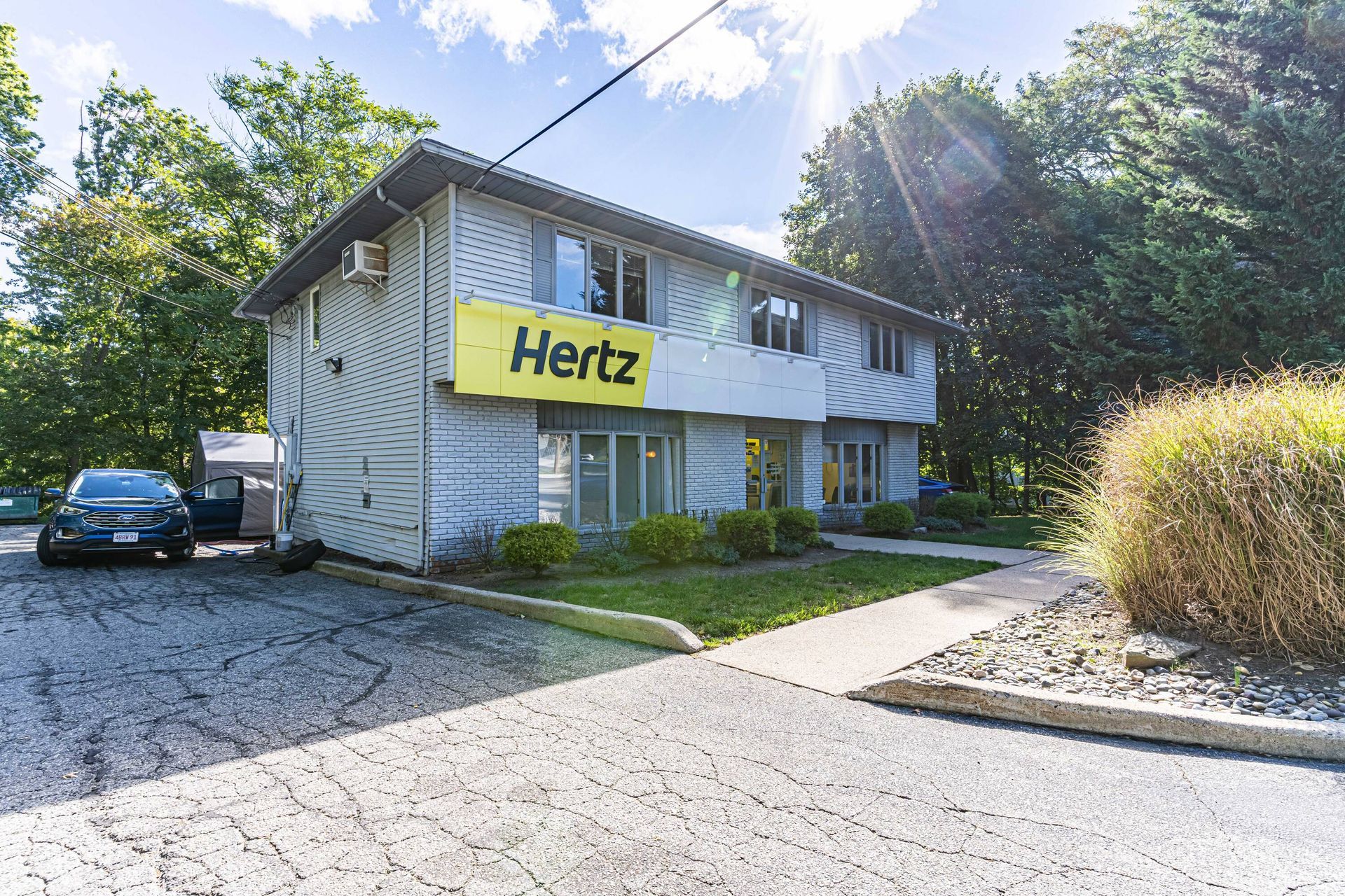 A hertz sign is on the side of a building