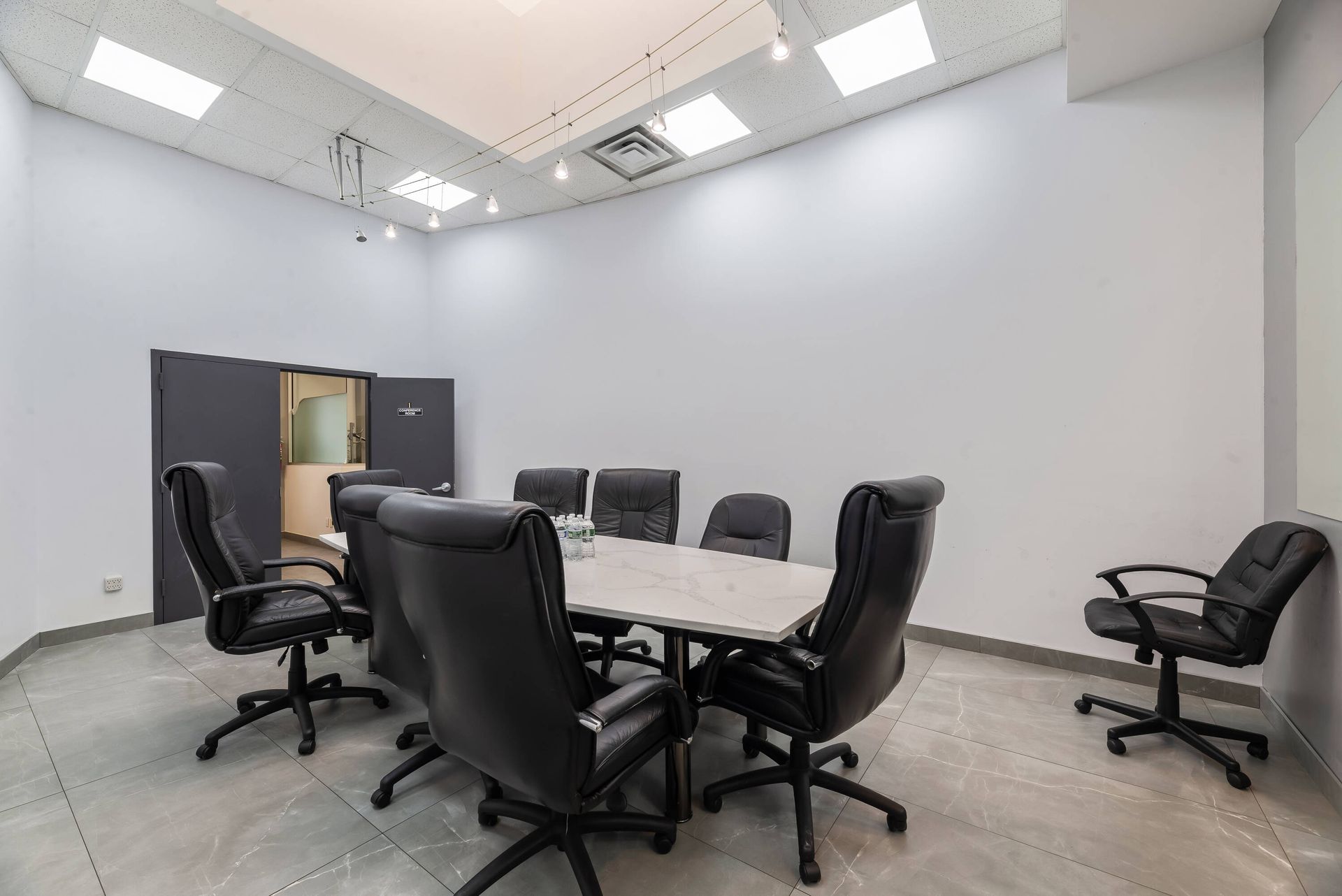 A conference room with a table and chairs in it.