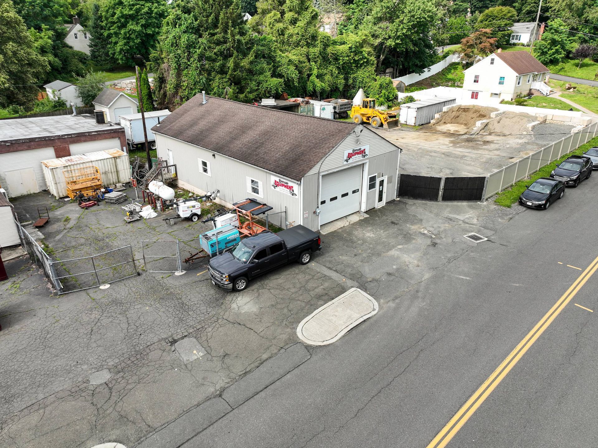 An aerial view of a garage with a truck parked in front of it.