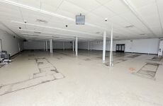 A large empty room with a white ceiling and columns.