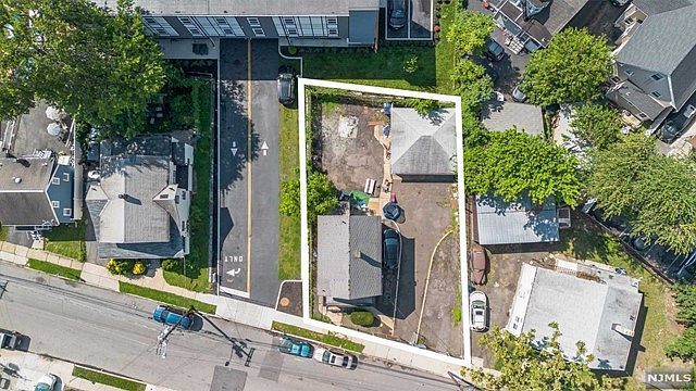 An aerial view of a residential area with a lot of houses and trees.