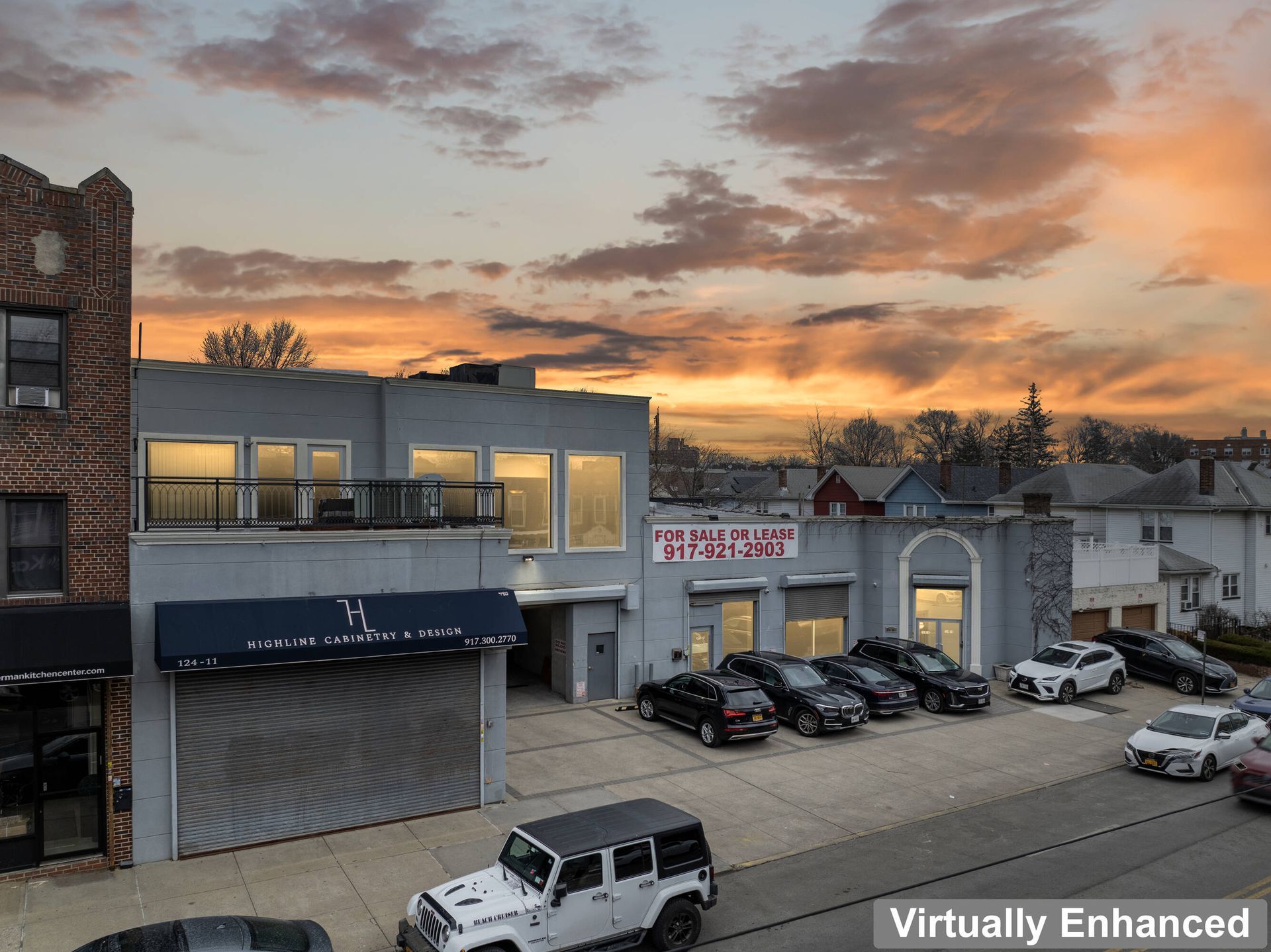 A jeep is parked in front of a building at sunset.