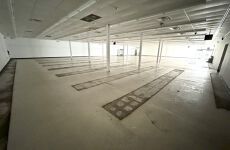 A large empty room with a lot of lines on the floor.