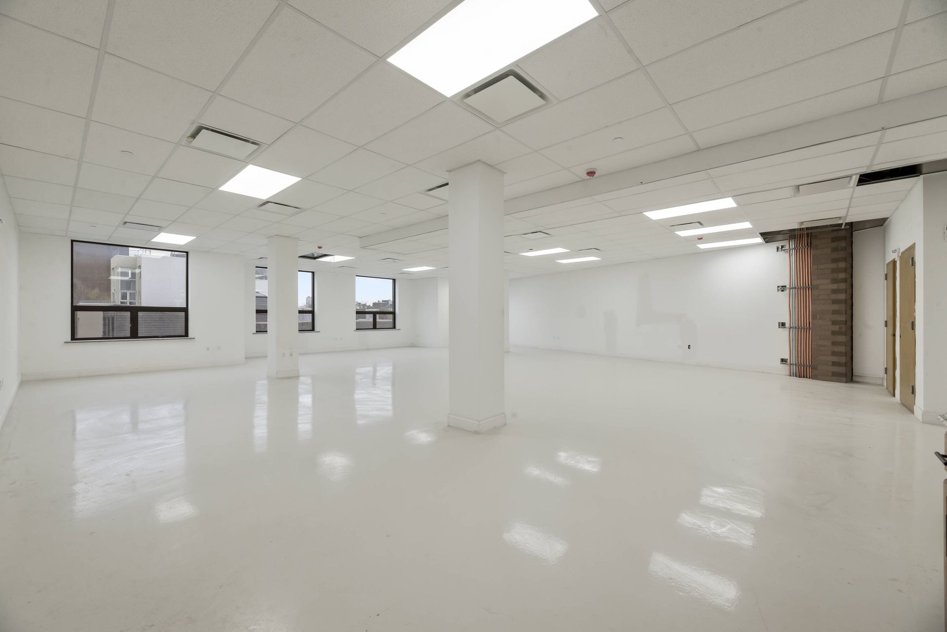 A large empty room with white walls and a white floor.