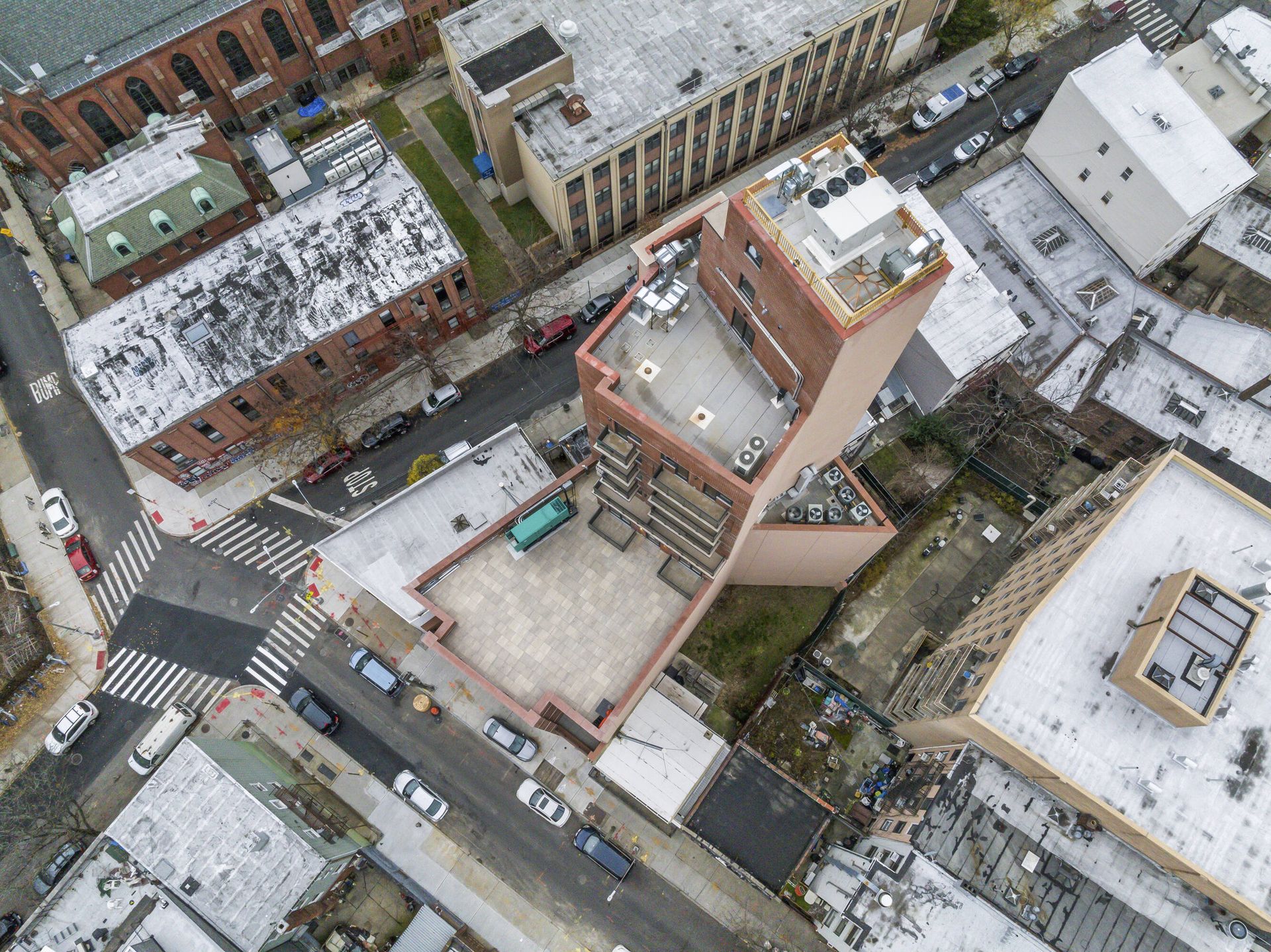 An aerial view of a city with a large building in the middle.