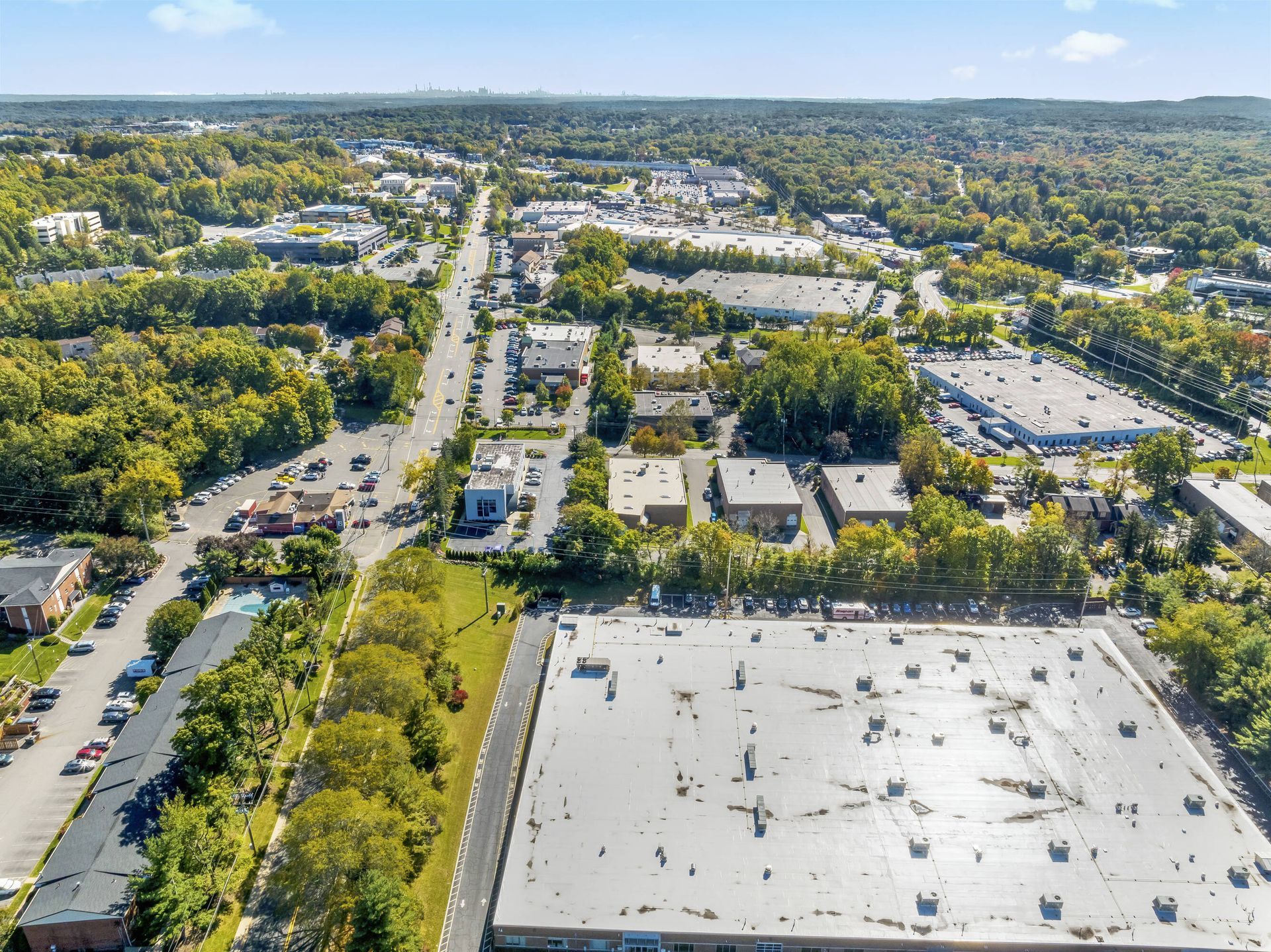 An aerial view of a city with a large building in the middle.