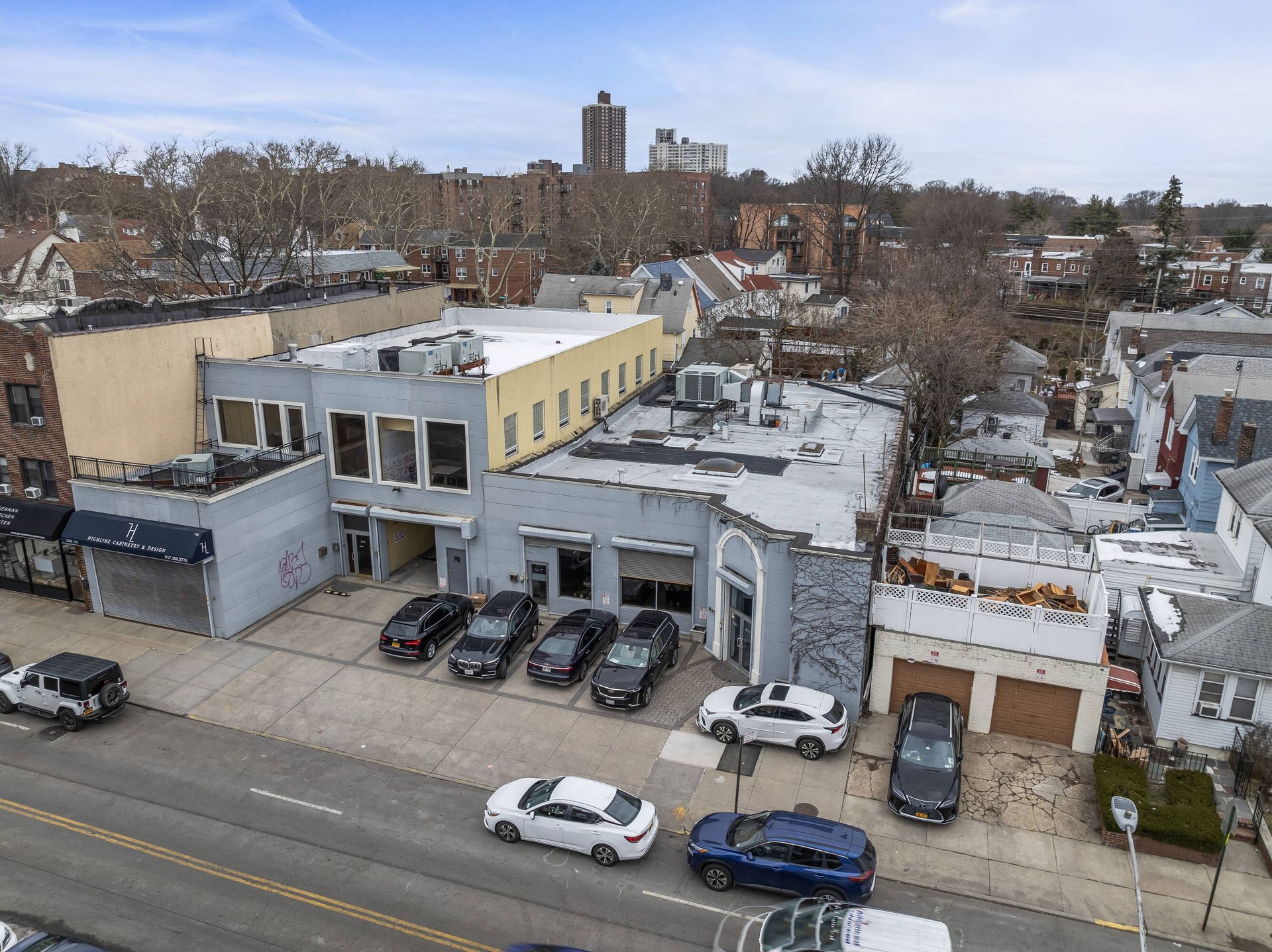 An aerial view of a building with cars parked in front of it.