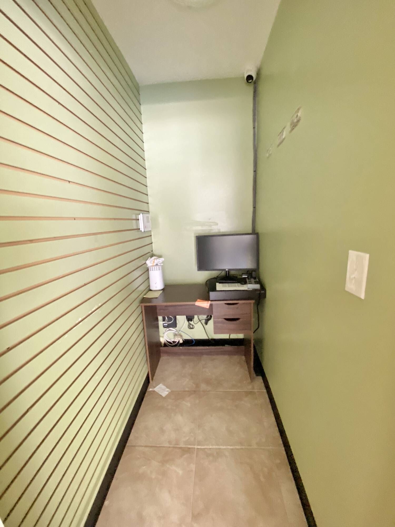 A small room with a desk and a computer on it