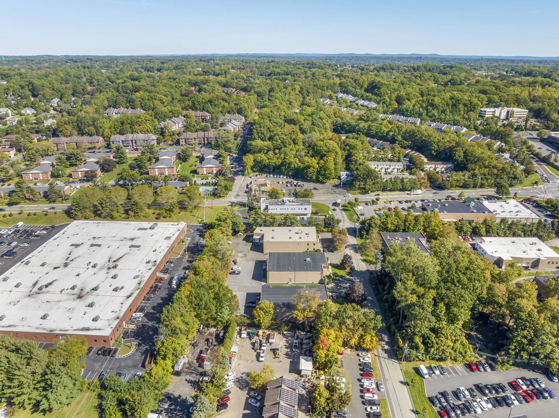 An aerial view of a city with lots of buildings and trees.