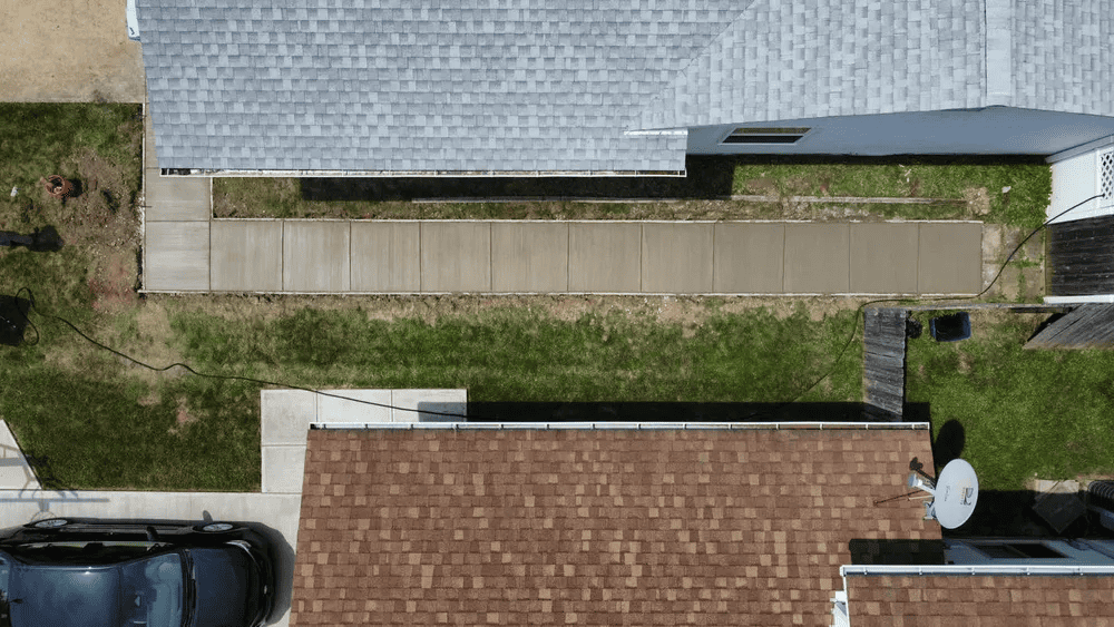 An aerial view of a house with a car parked in front of it.