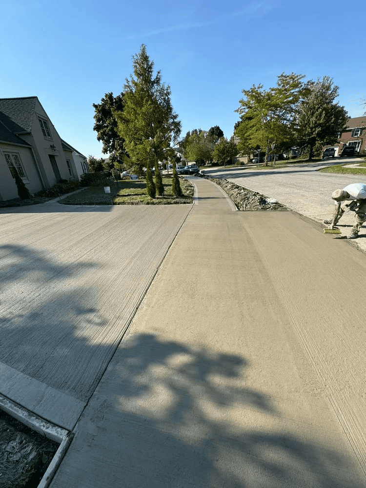 A concrete sidewalk is being built in a residential neighborhood.