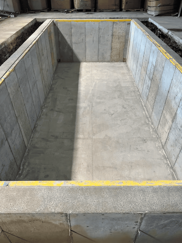A large concrete container is sitting in a warehouse.