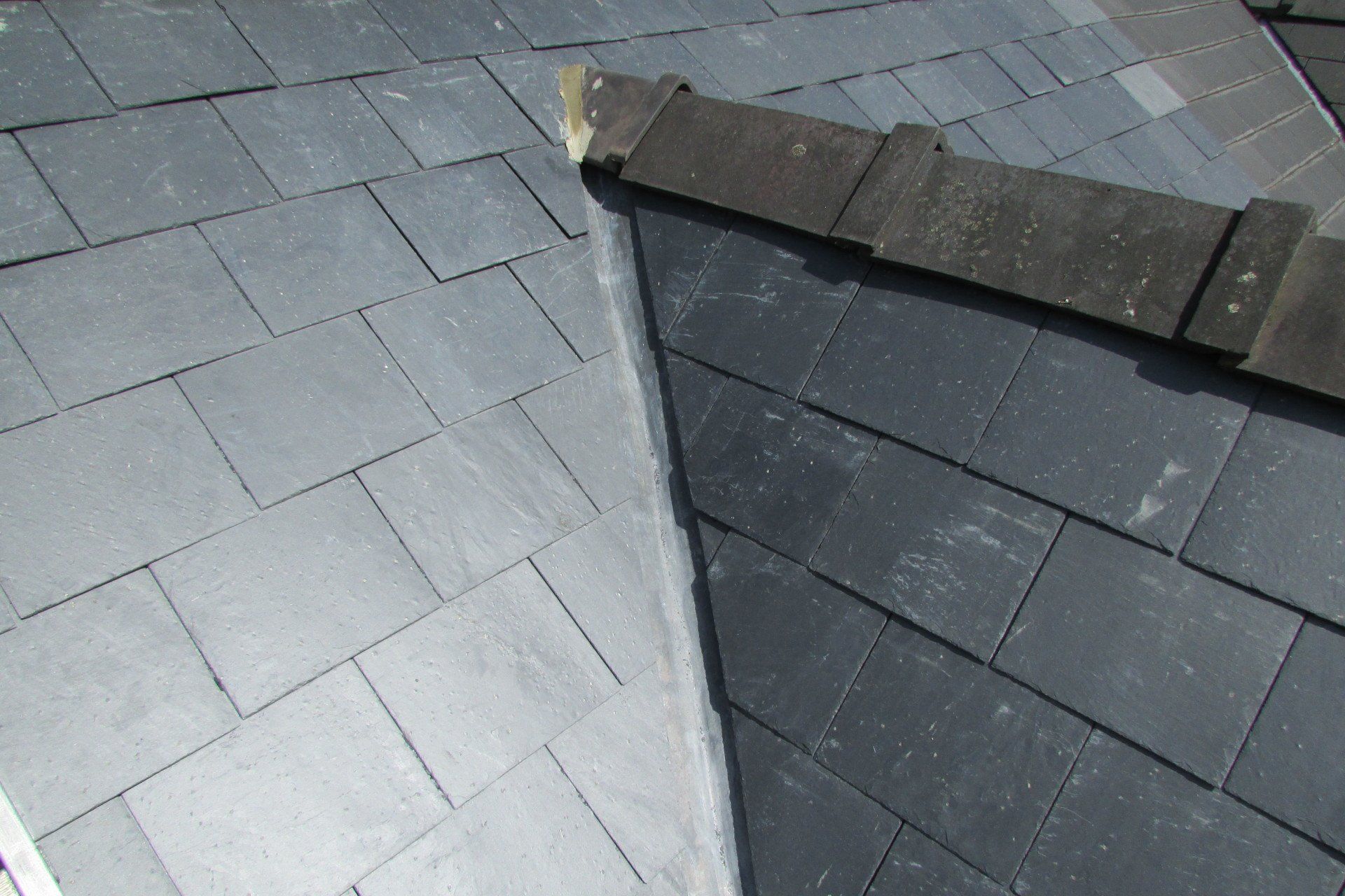 A close up of a roof with slate tiles on it