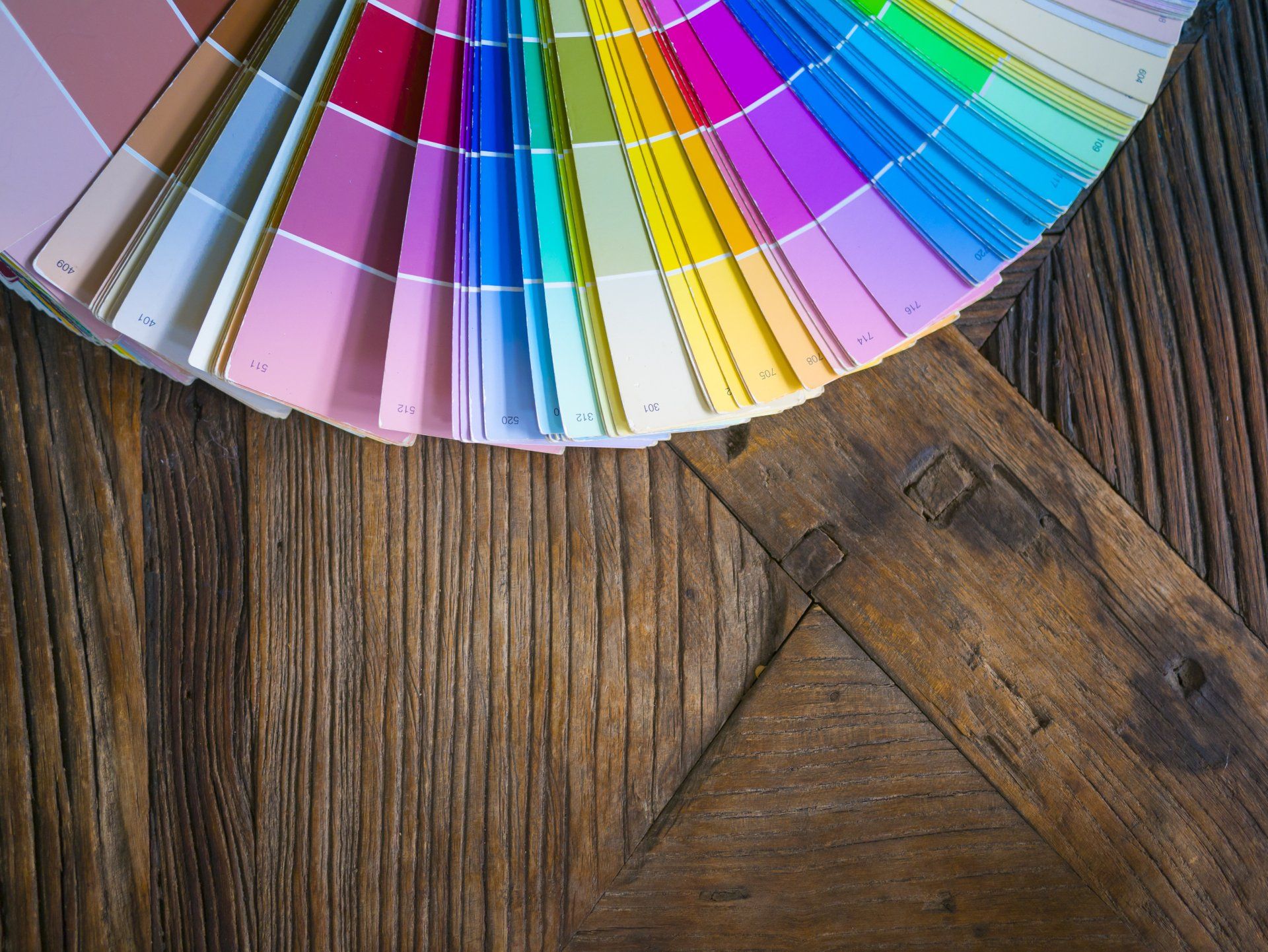 A fan of color samples on a wooden table