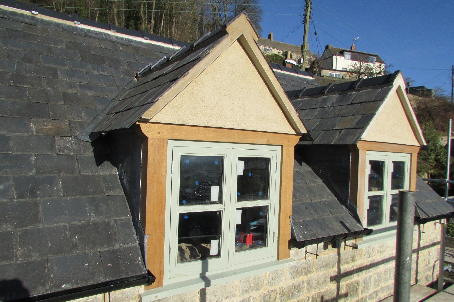 A building with a slate roof and two windows