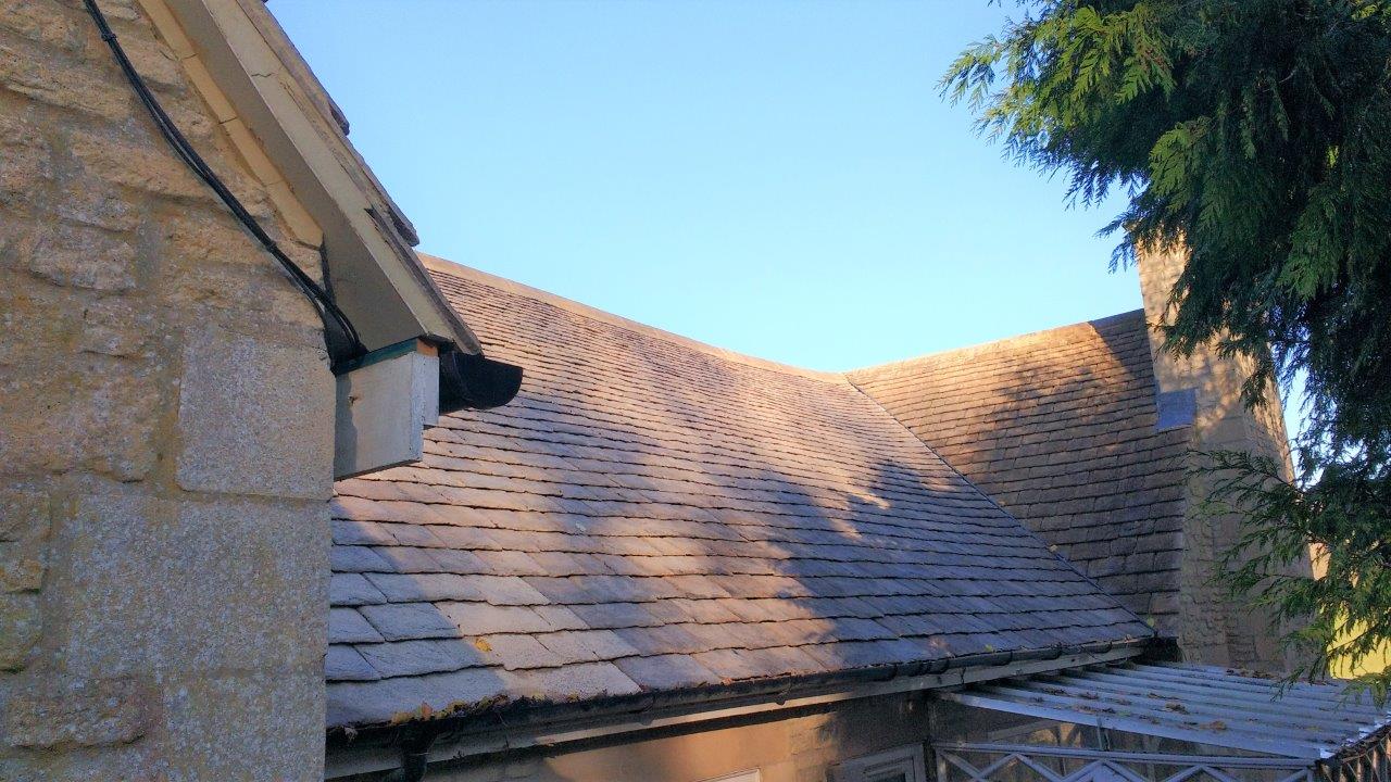 A roof of a building with a blue sky in the background.