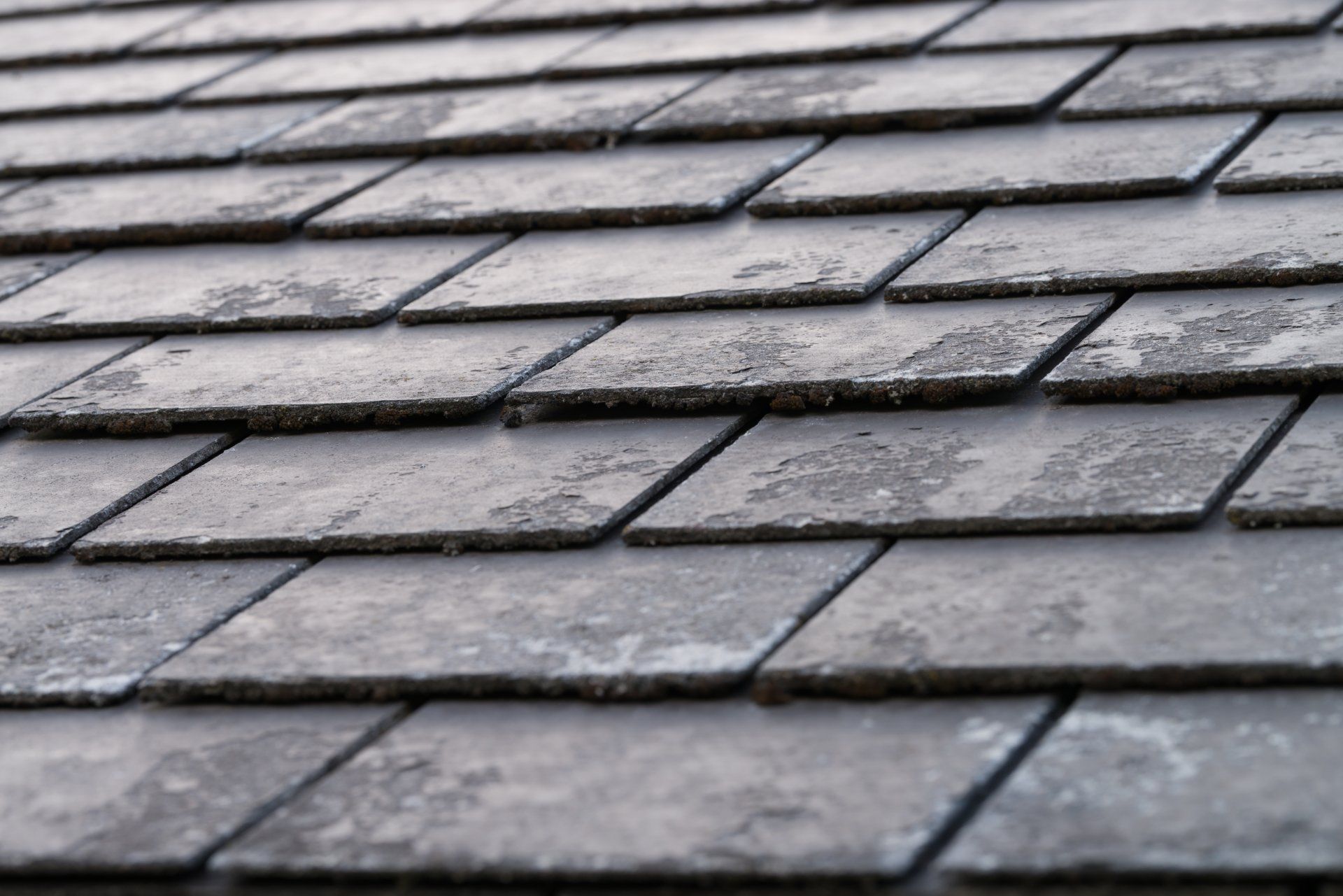 A close up of a roof made of slate tiles.