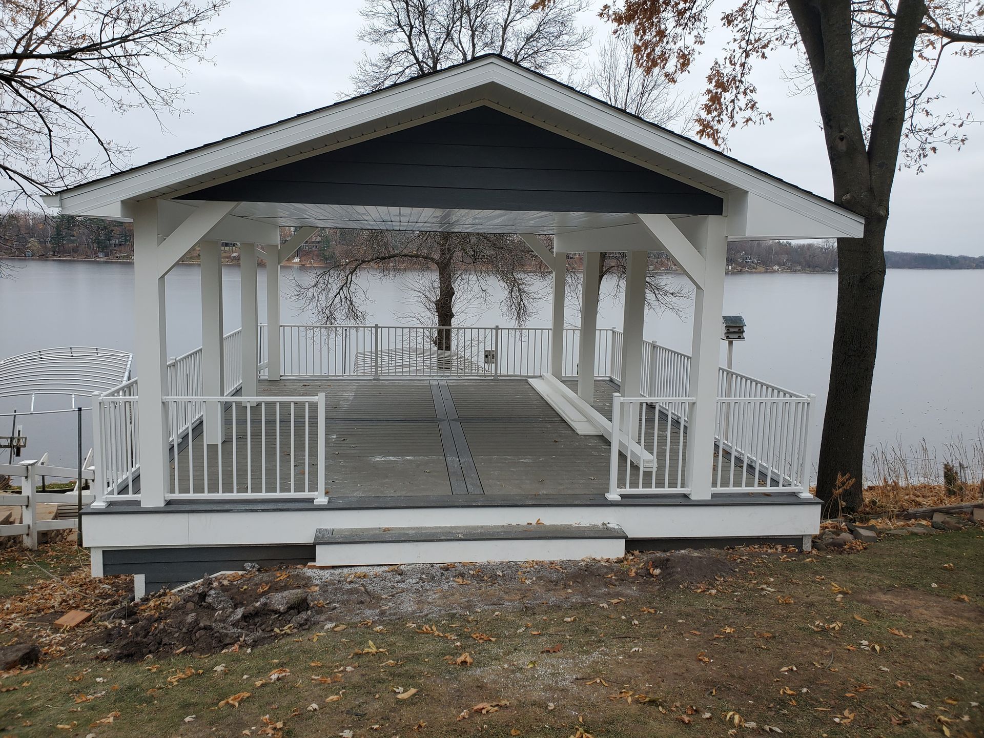 A white gazebo overlooking a body of water