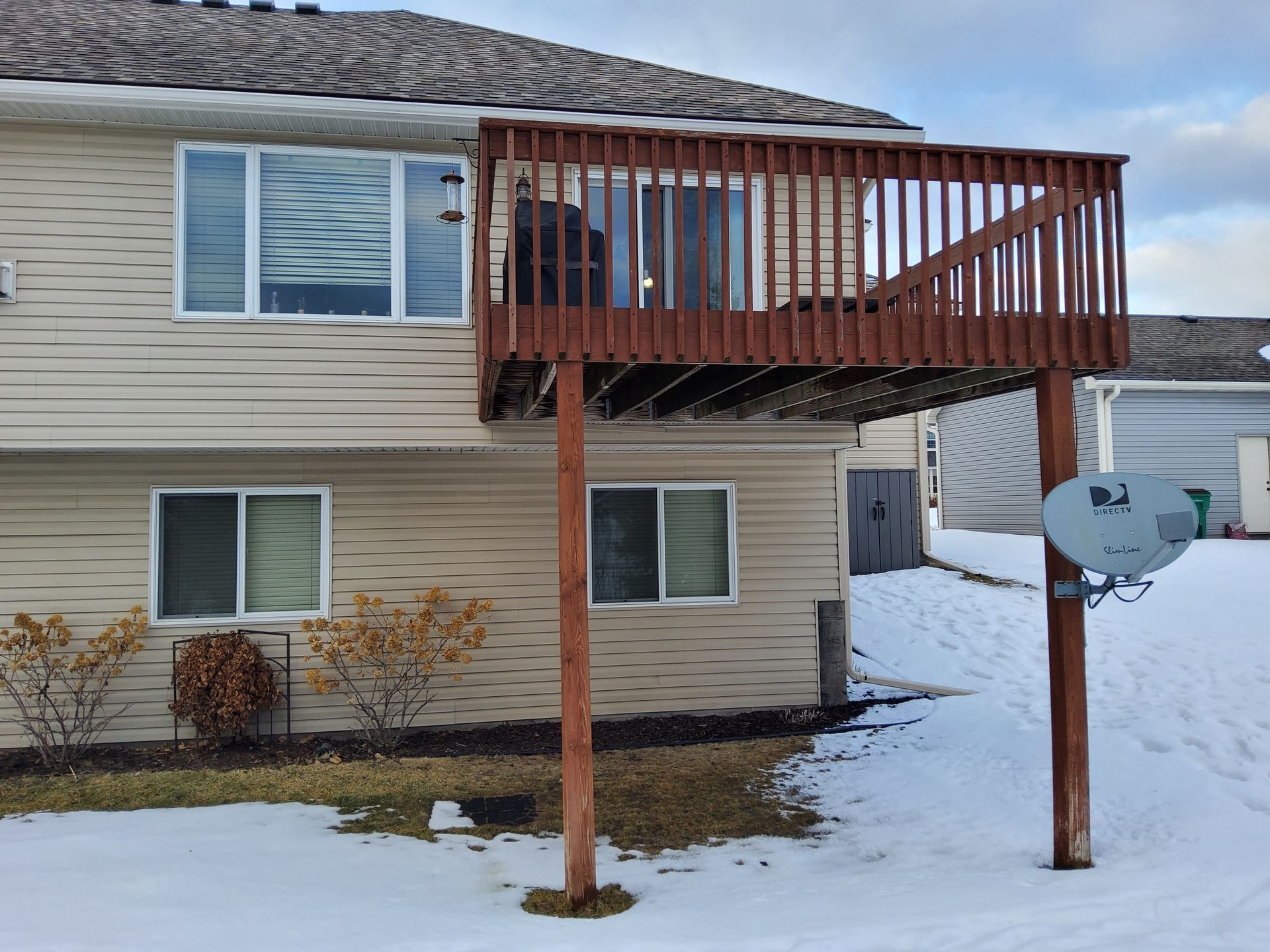 A house with a deck and a satellite dish