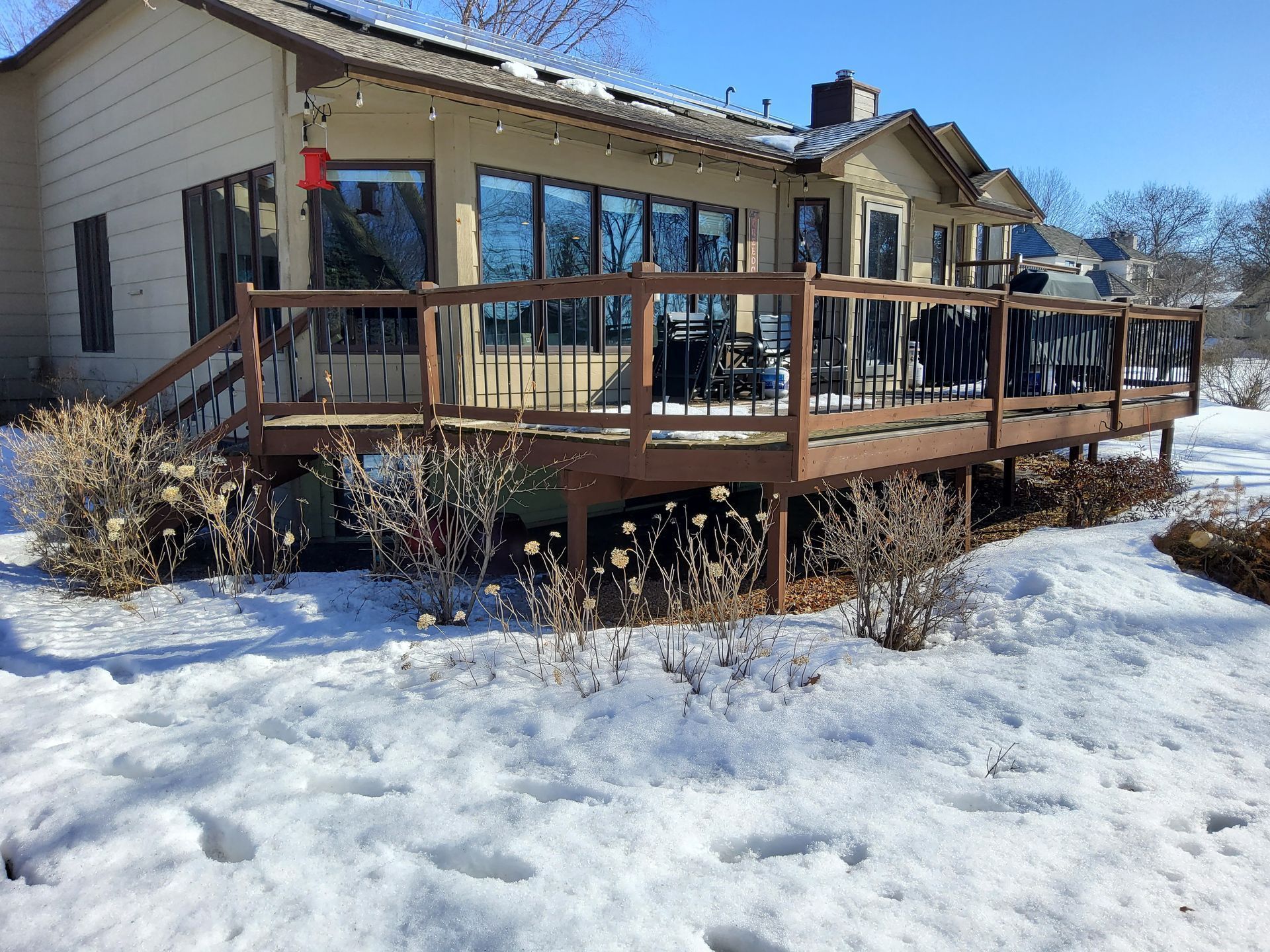 A house with a large deck in the snow