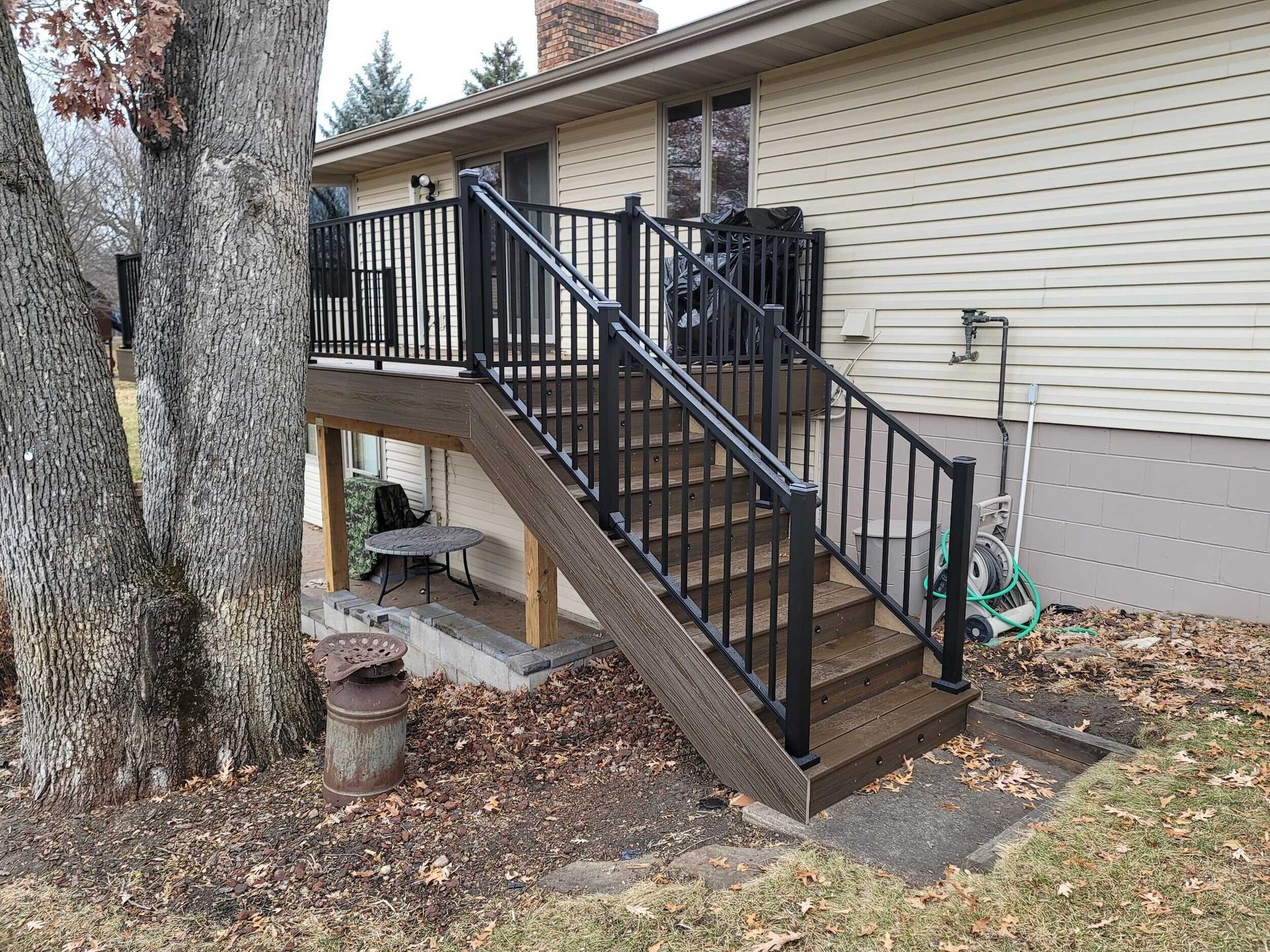 A house with a deck and stairs leading up to it.