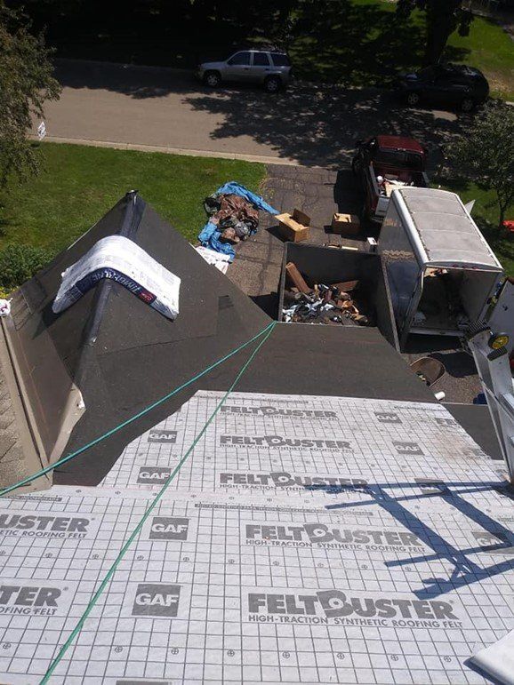 An aerial view of a roof being installed with felt duster.