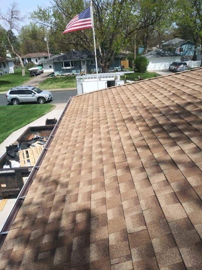 A brown roof with an american flag on top of it
