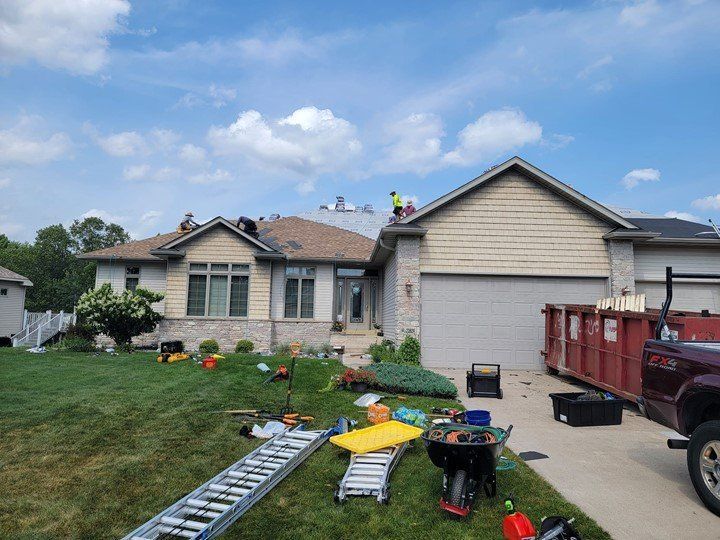 A truck is parked in front of a house that is being remodeled.