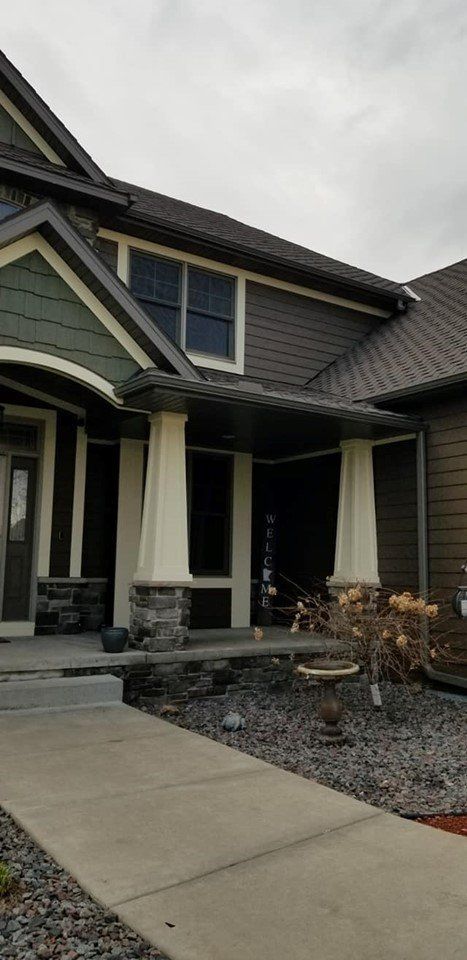 A large house with a porch and a walkway leading to it.