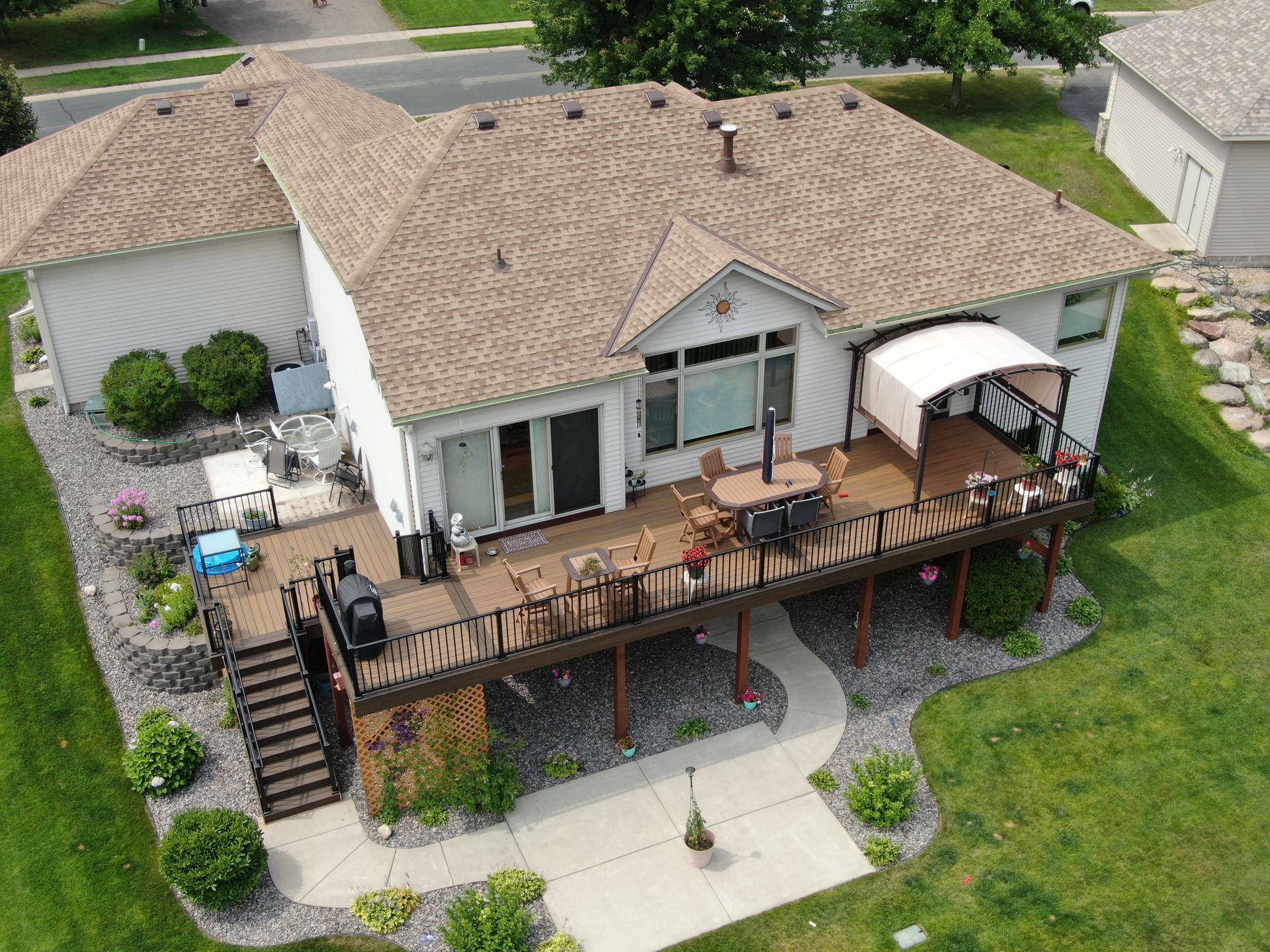 An aerial view of a house with a large deck.